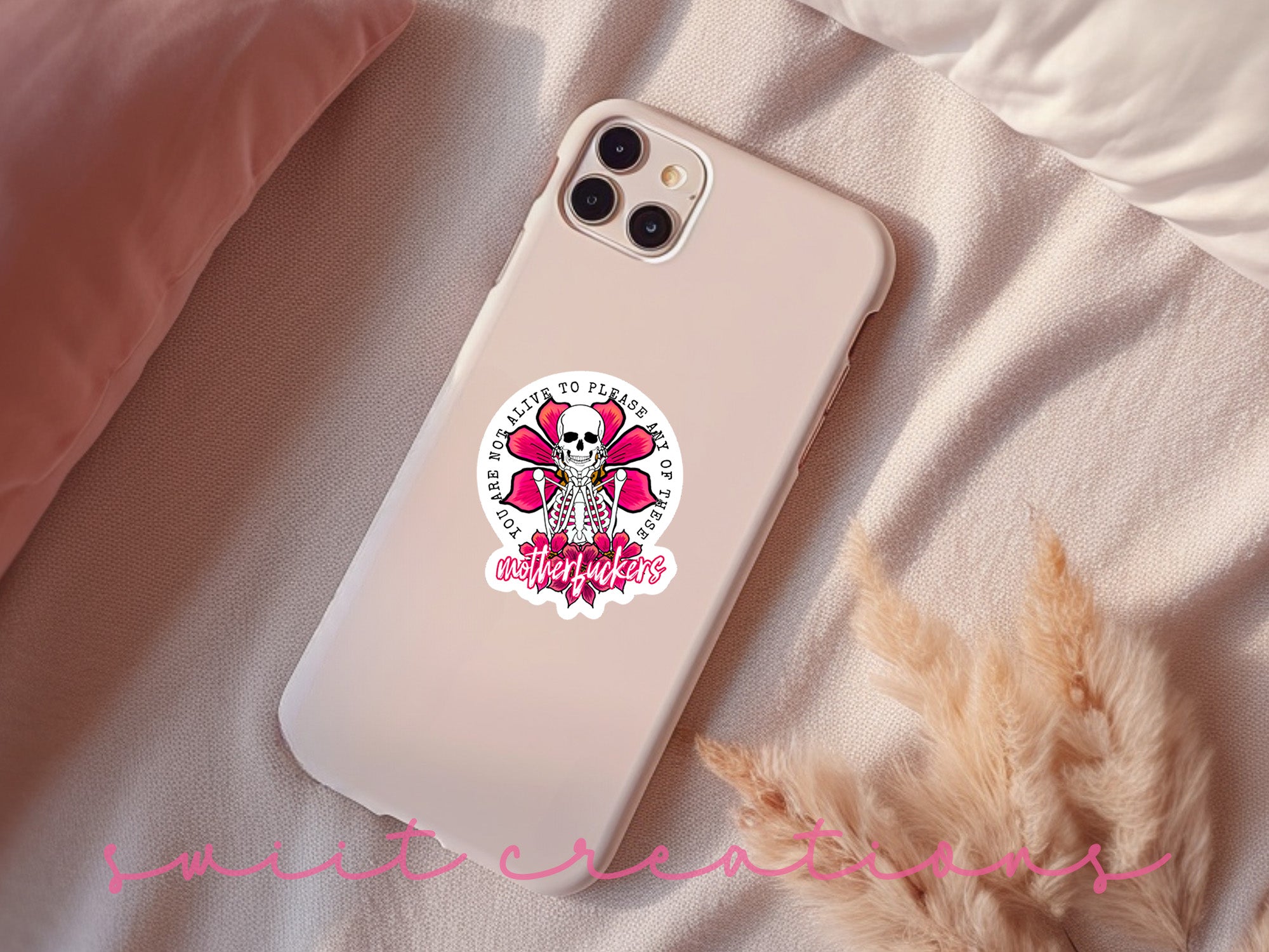 a phone case with a pink skull on it