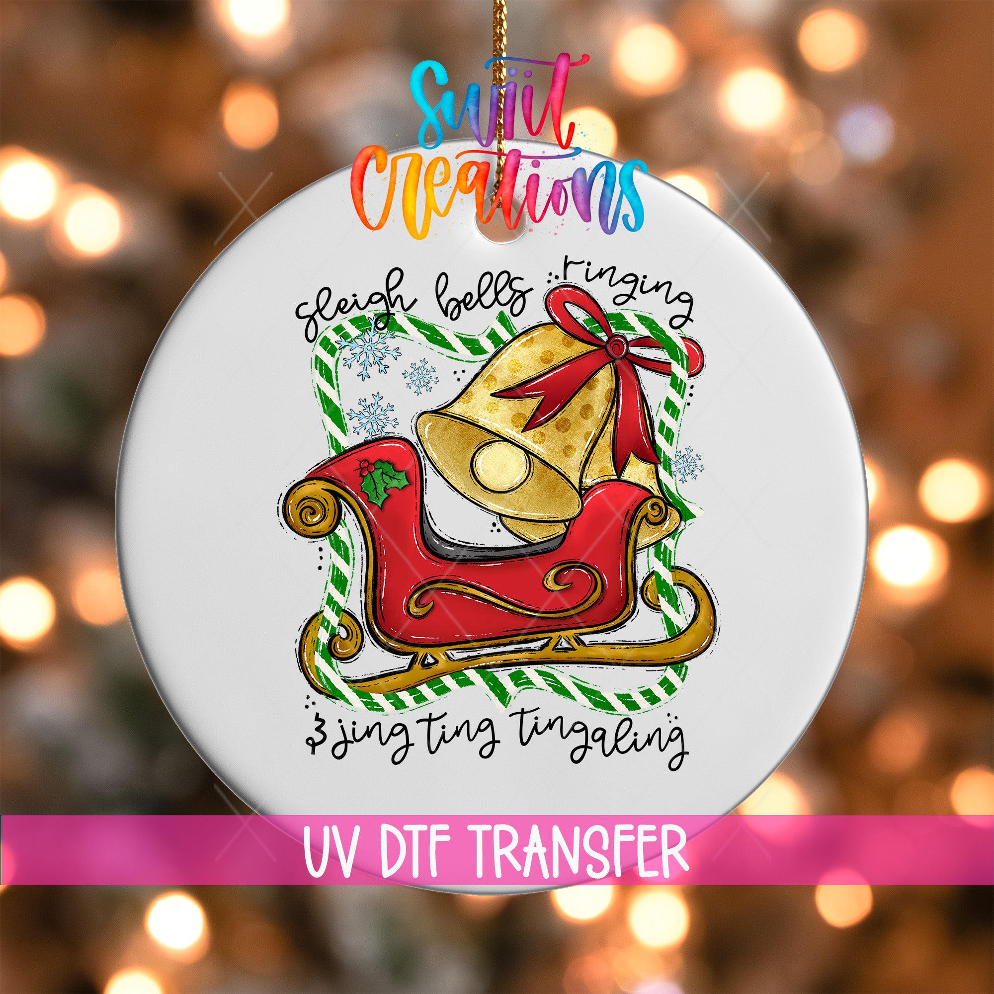 A white ornament with a red sleigh and a bell, surrounded by snowflakes, is hanging against a background of colorful lights.