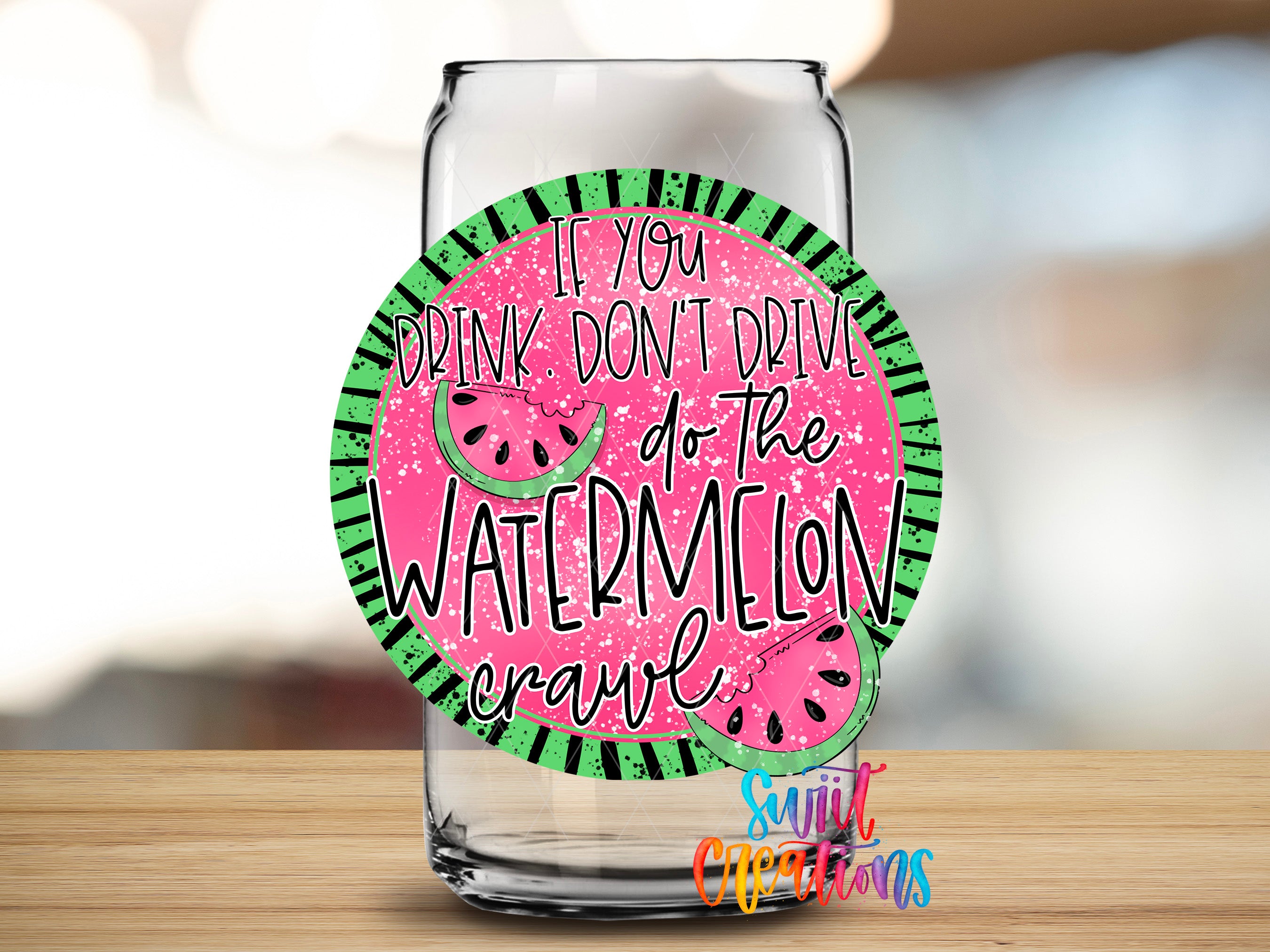 a clear glass can with a colorful sticker on it. The sticker has a message that reads "If you drink don't drive do the watermelon crawl".