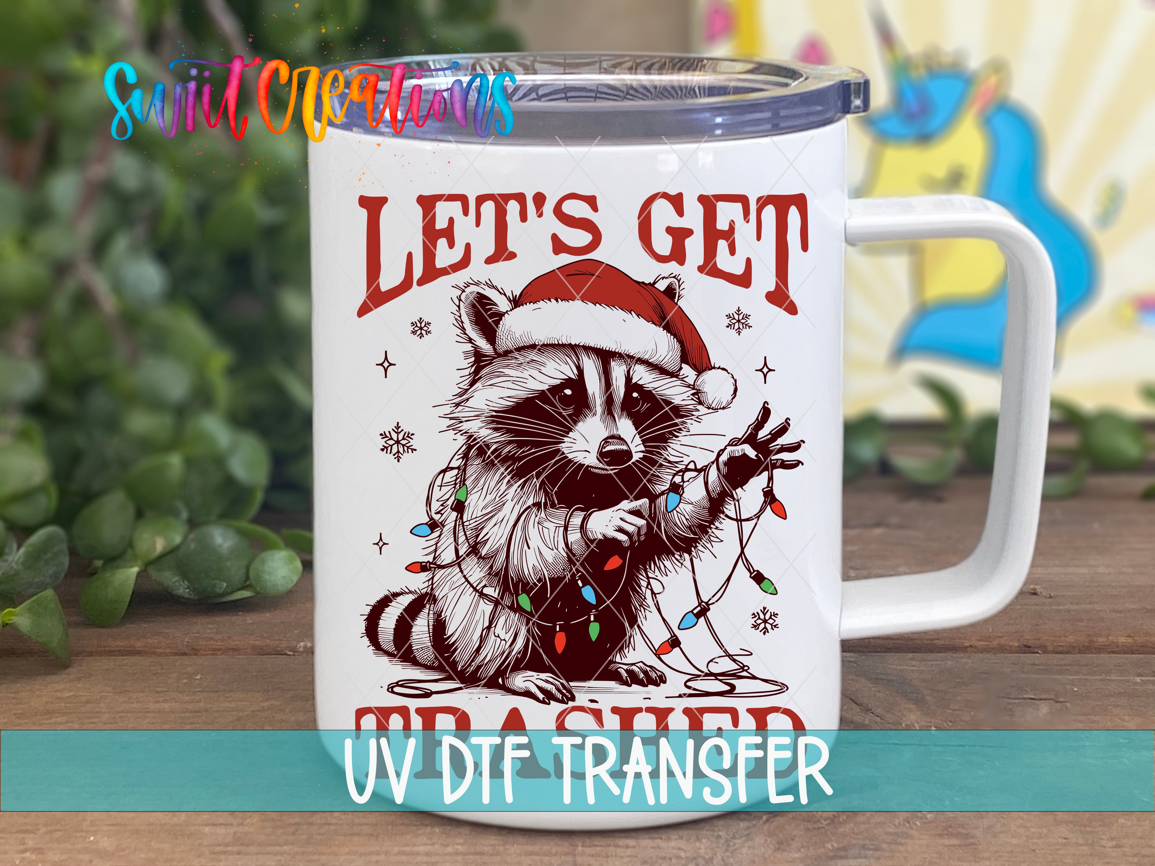 A mug with a raccoon wearing a Santa hat and holding Christmas lights, with the text "Let's get trash" printed on it.