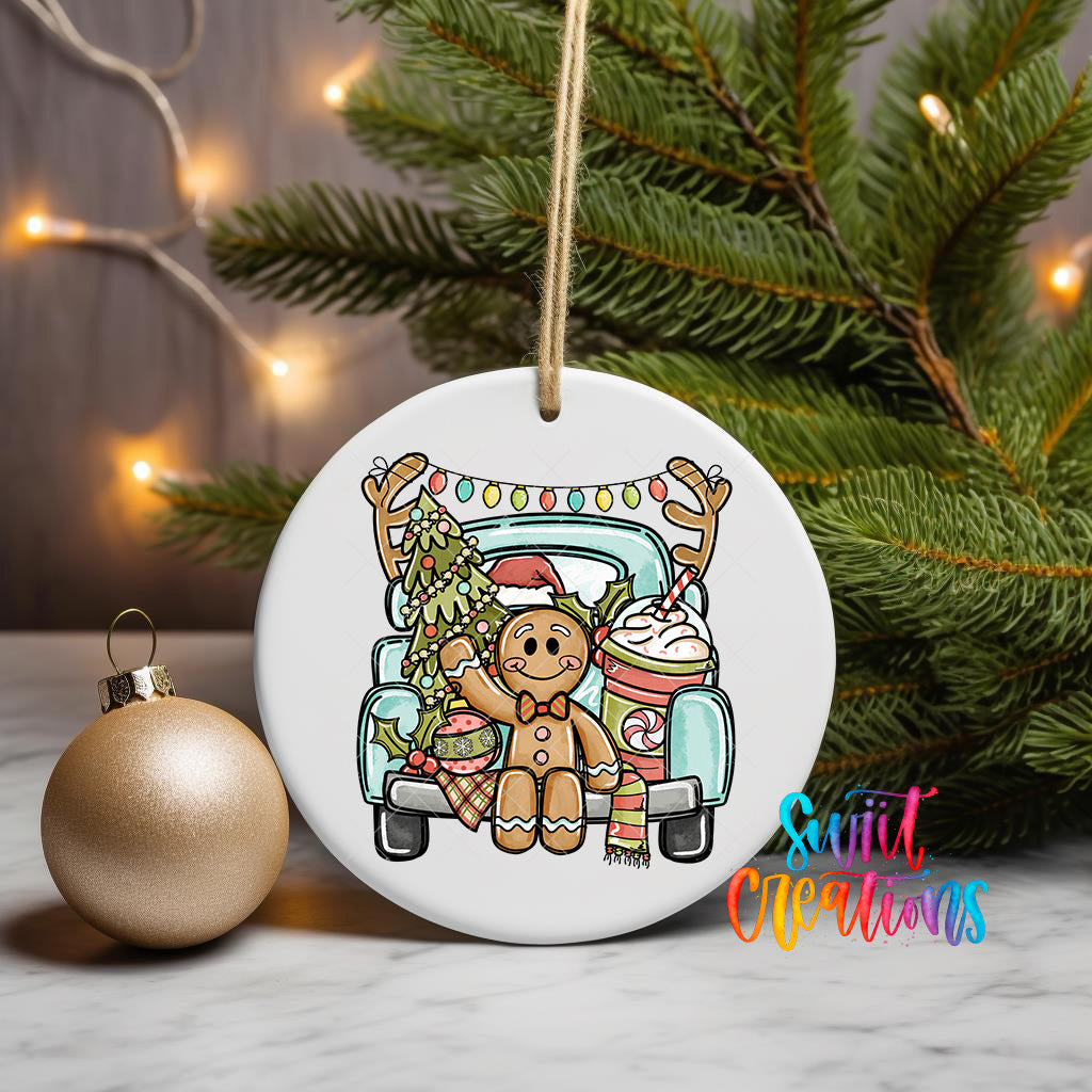 A white ceramic ornament featuring a gingerbread man sitting in the back of a blue truck, surrounded by Christmas decorations and a Christmas tree.