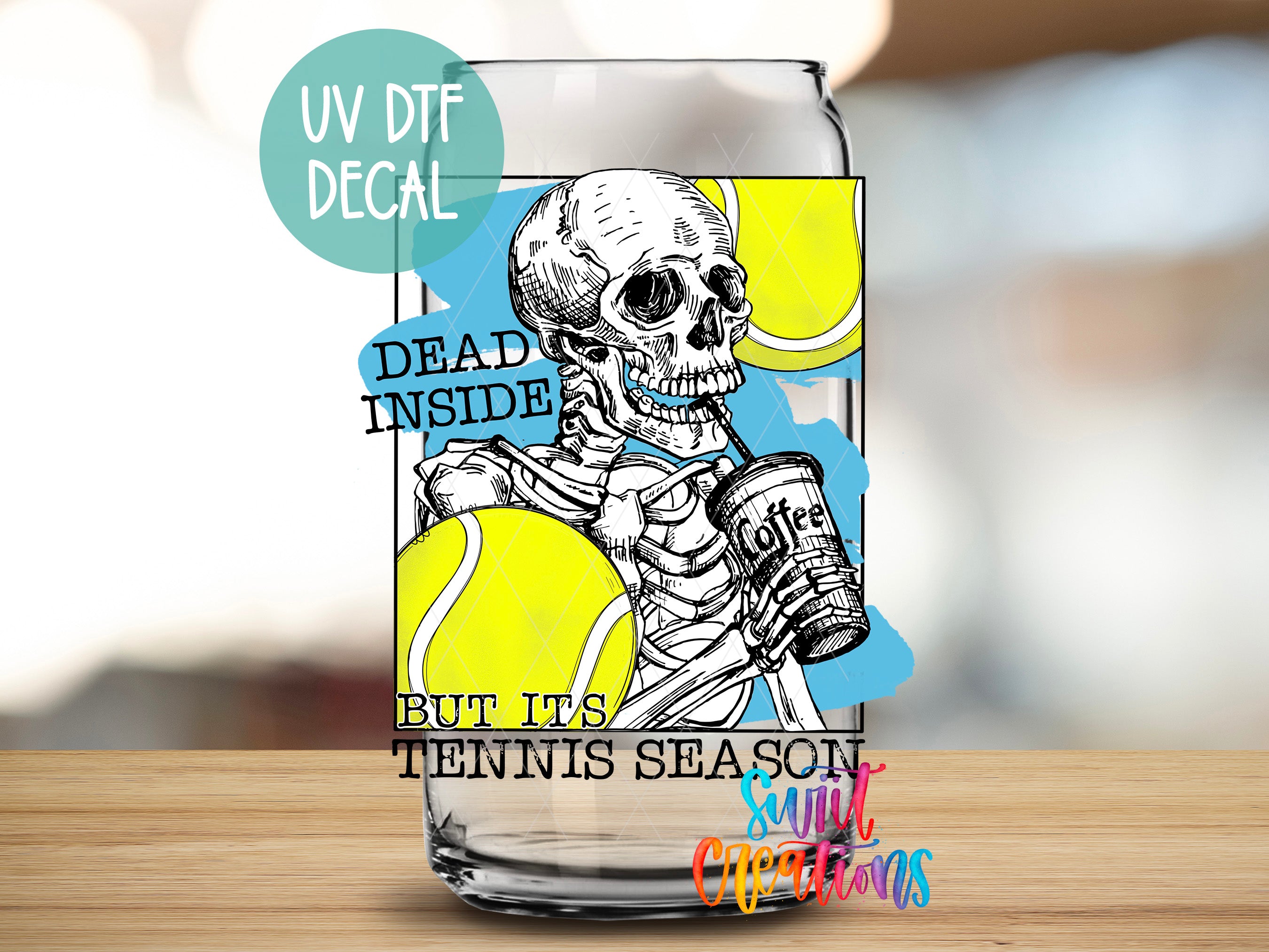 a glass with a picture of a skeleton holding a tennis ball