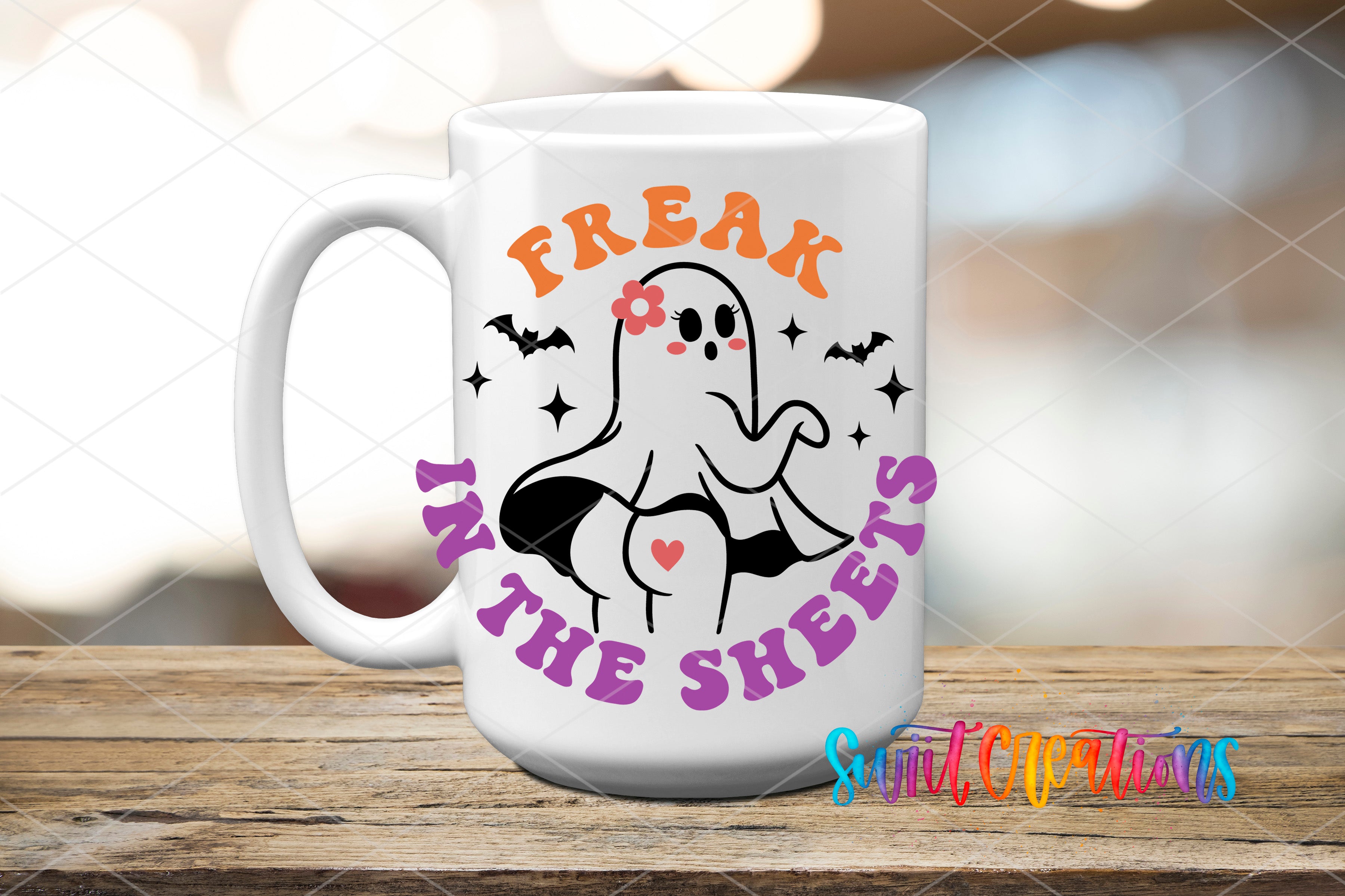 A white mug with a graphic design featuring a ghost character and the text "Freak in the Sheets" printed on it.