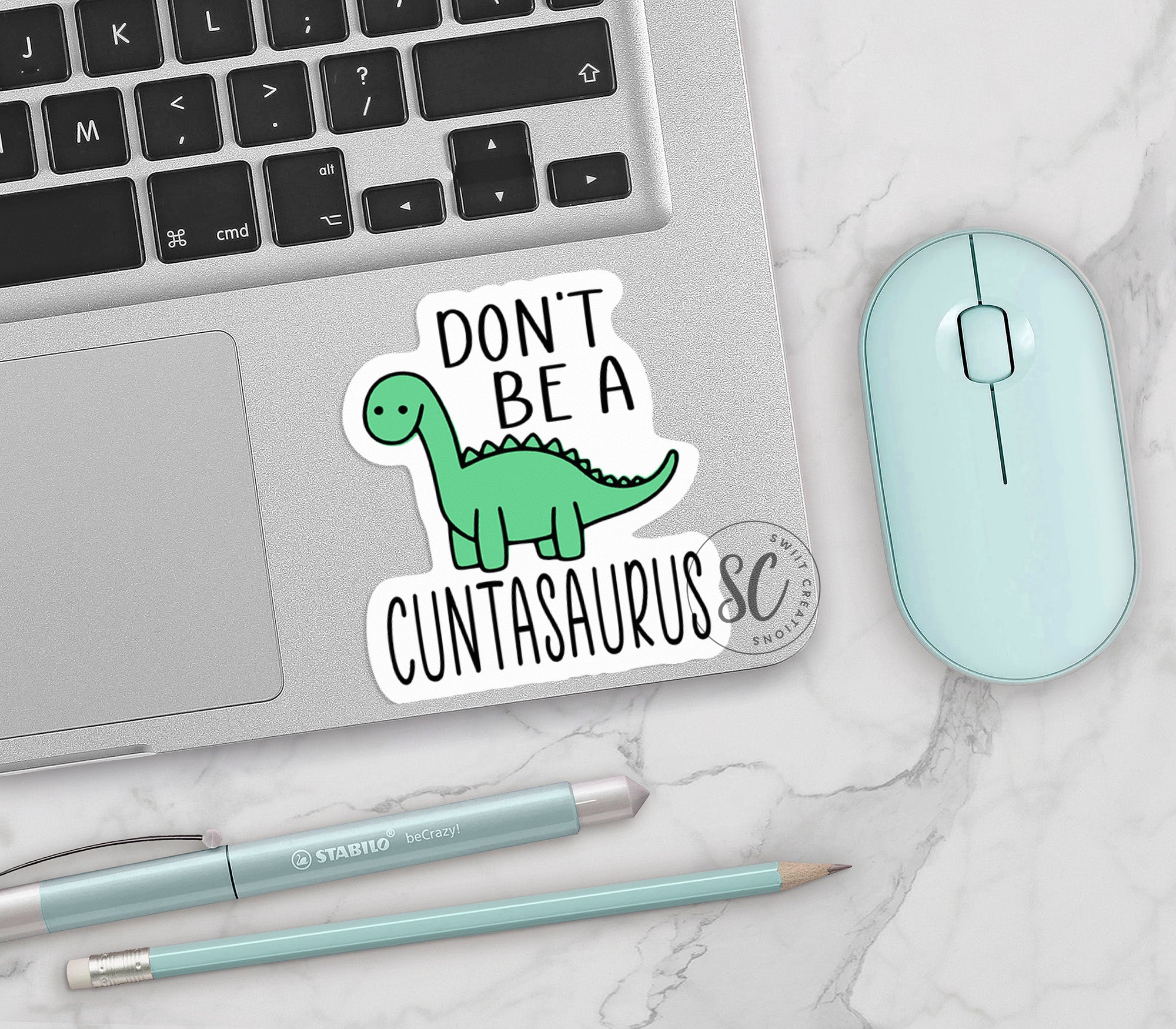 a sticker that says don't be a dinosaurus on it next to