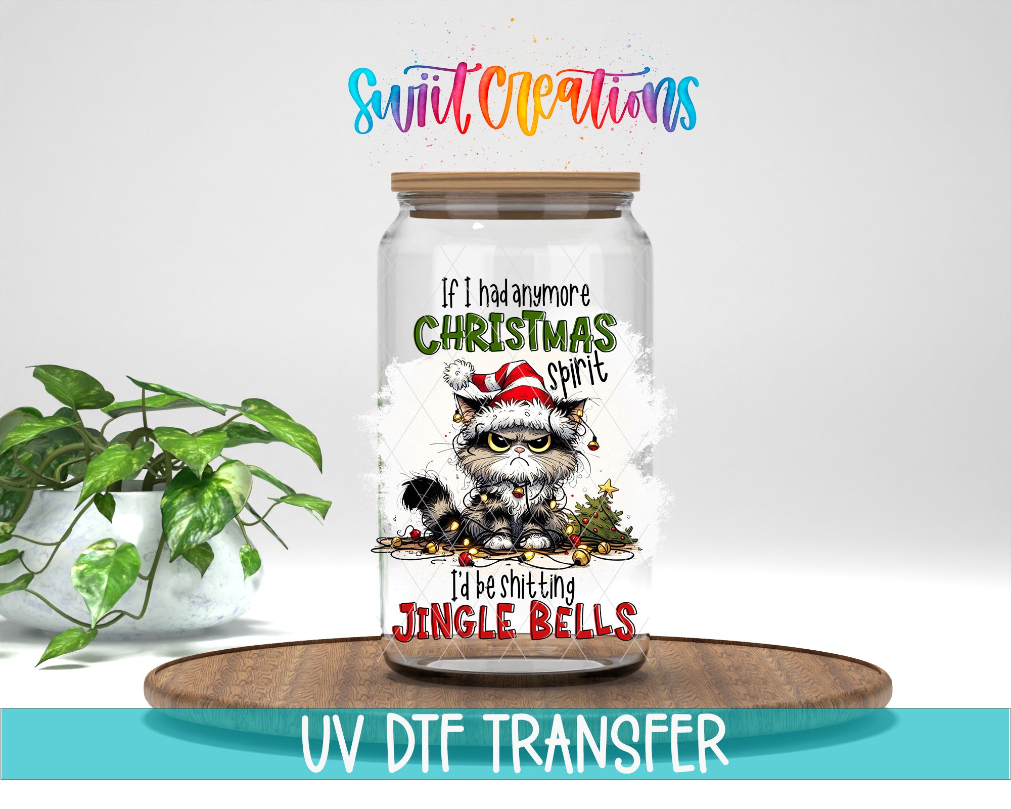 A glass jar with a cat wearing a Santa hat and surrounded by Christmas decorations, placed on a wooden tray. The jar has a label that says "If I had ever Christmas spirit, I'd be shifting Jingle Bells".
