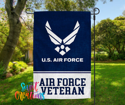 A blue flag with the U.S. Air Force logo and the text "AIR FORCE VETERAN" is displayed in a grassy outdoor setting.