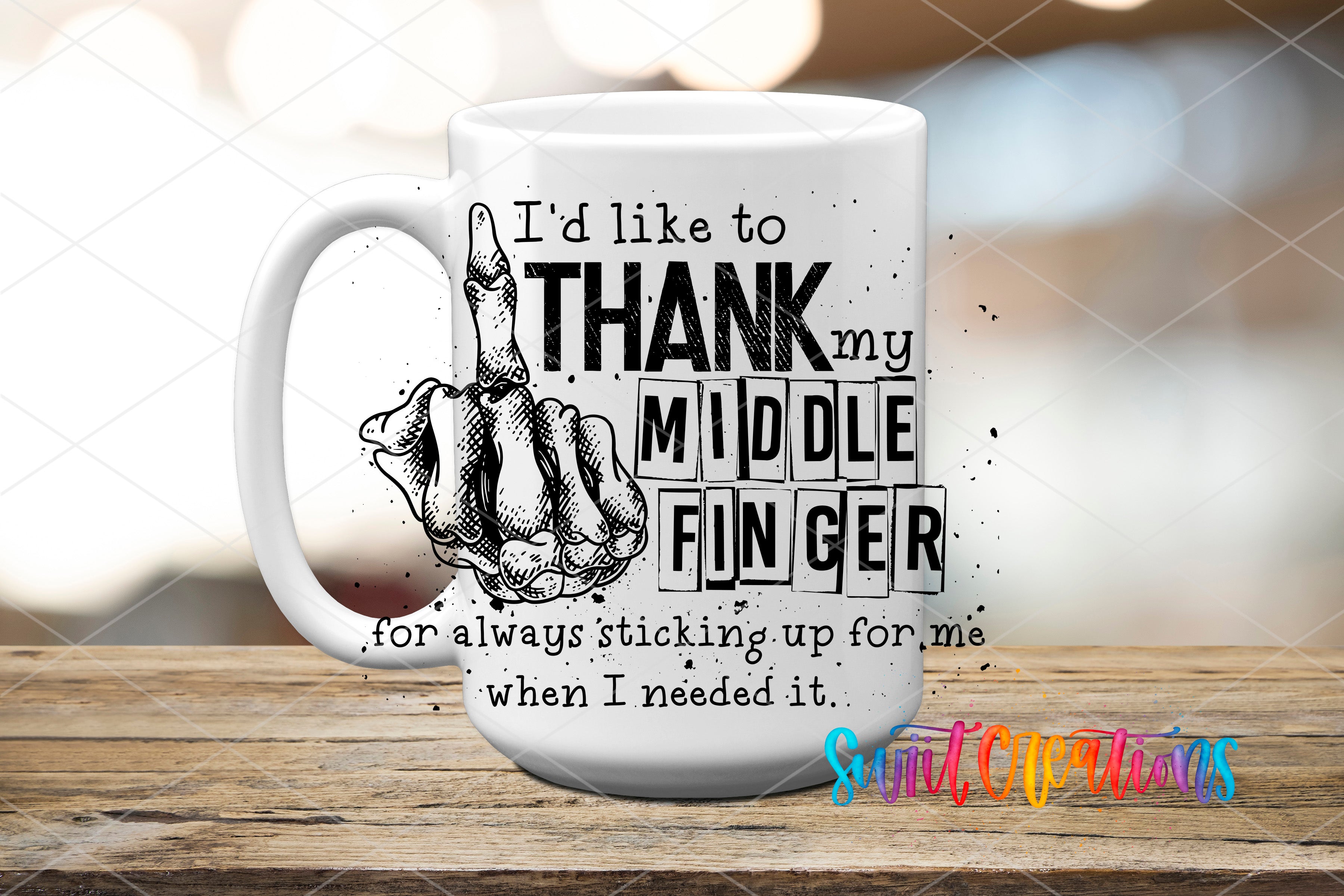 A white mug with a humorous text and graphic design printed on it, sitting on a wooden surface.