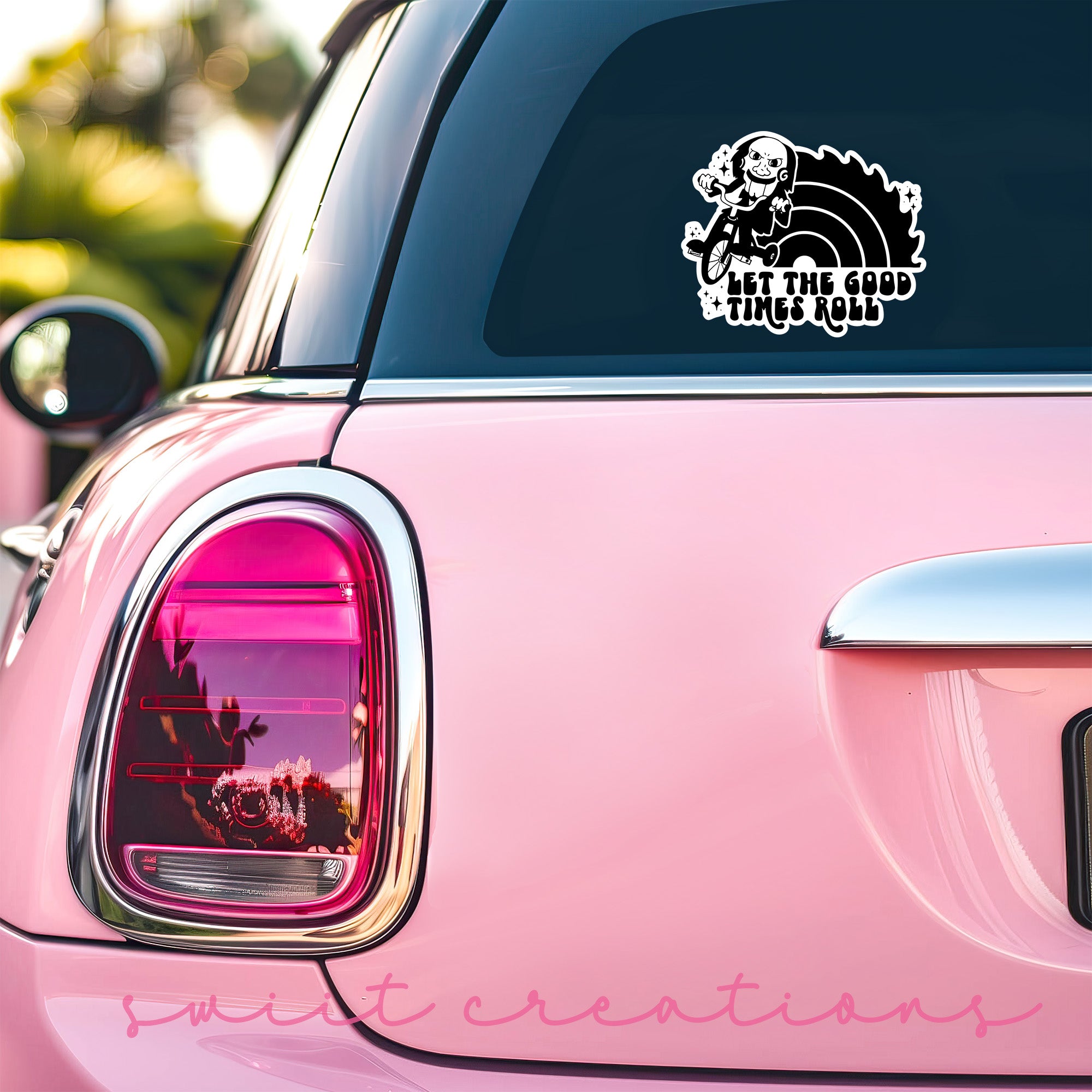 a pink car with a sticker on it