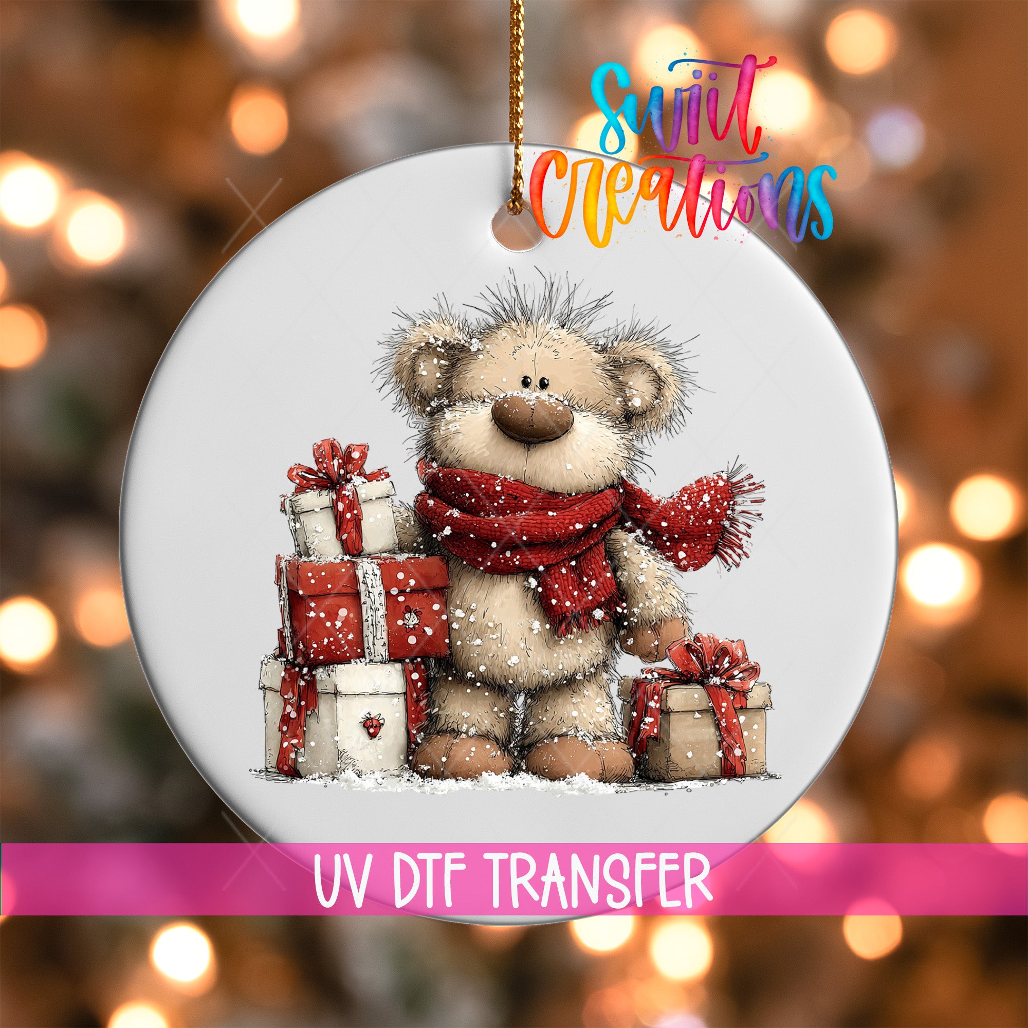 A white ornament with a teddy bear and presents, surrounded by snow, against a blurred background with Christmas lights.