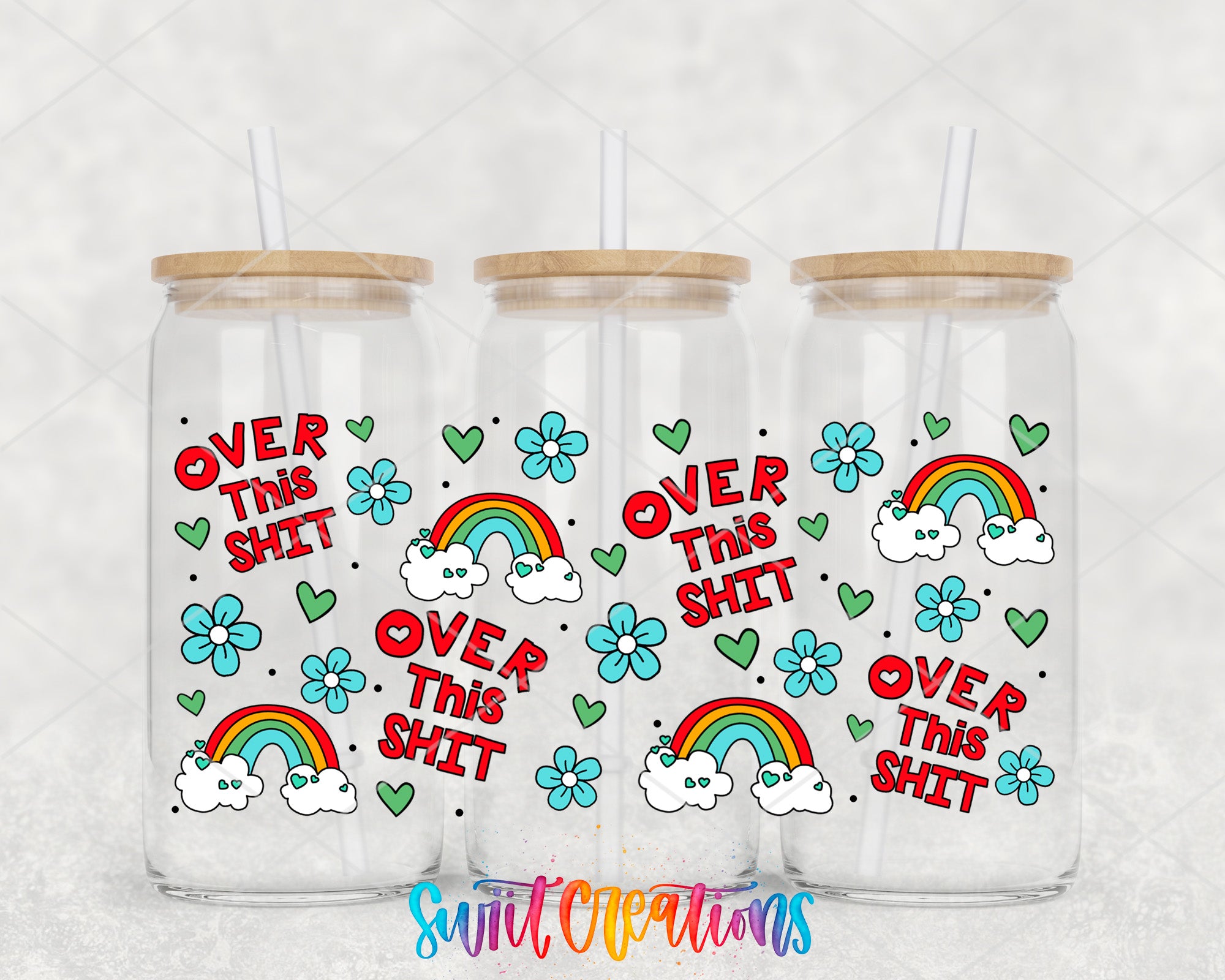 three glass tumblers with colorful designs and text on them.