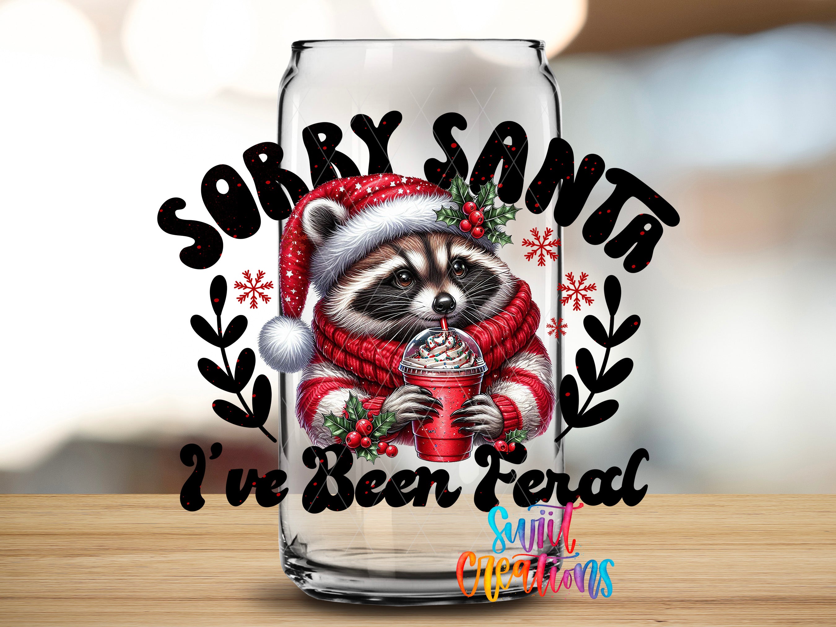 A glass with a raccoon wearing a Santa hat and scarf, holding a drink, and surrounded by snowflakes and the text "Sorry Santa I've Been Fernal"