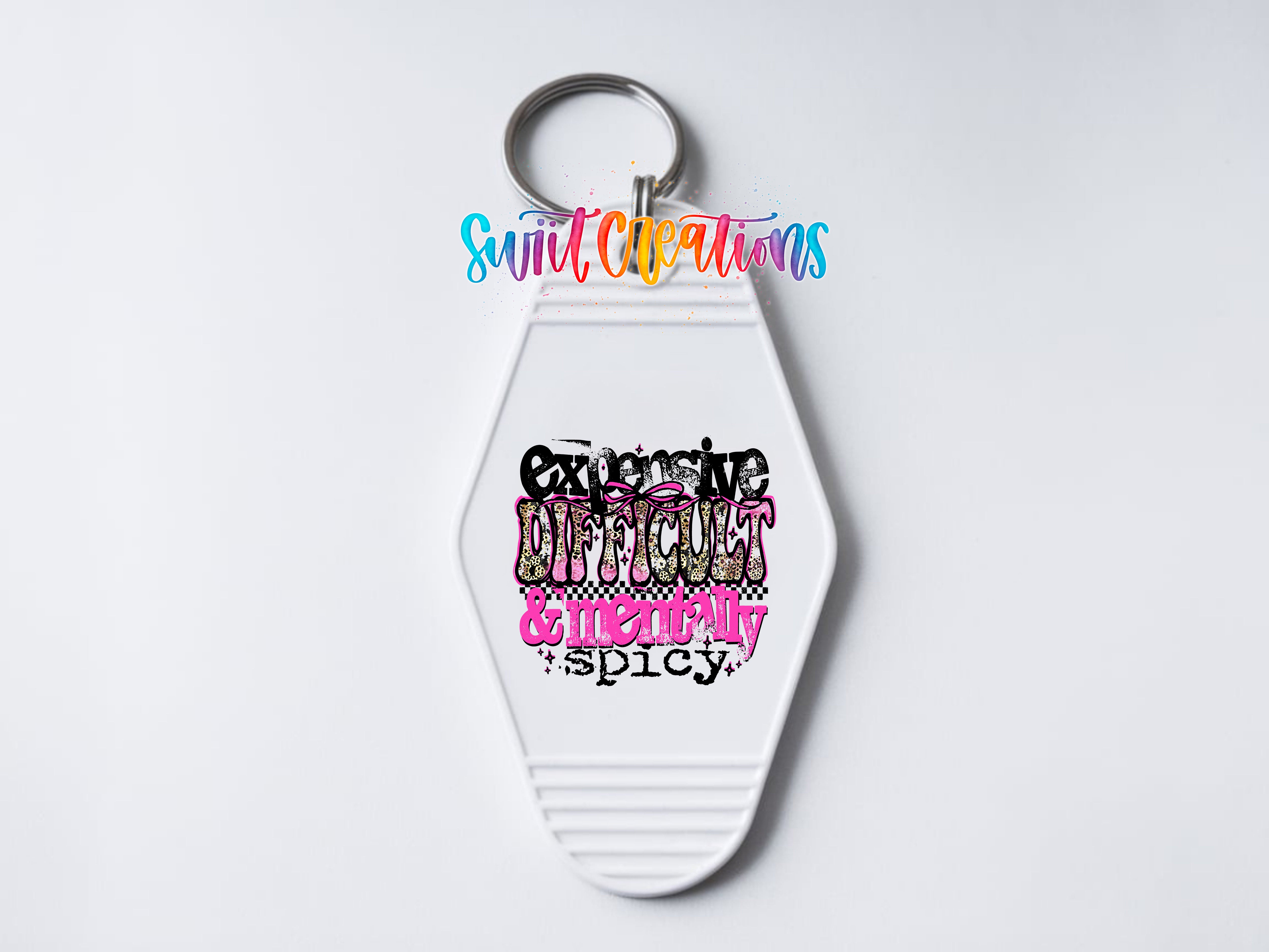 A keychain with a colorful design featuring the text "Excessive Difficulty & Emotional Spicy" in a stylized font.