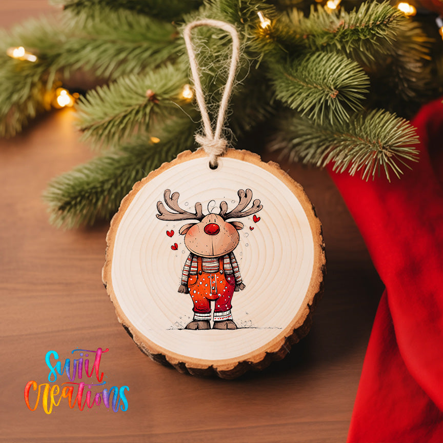 A wooden ornament featuring a cartoon reindeer with antlers and a red nose, hanging on a Christmas tree.