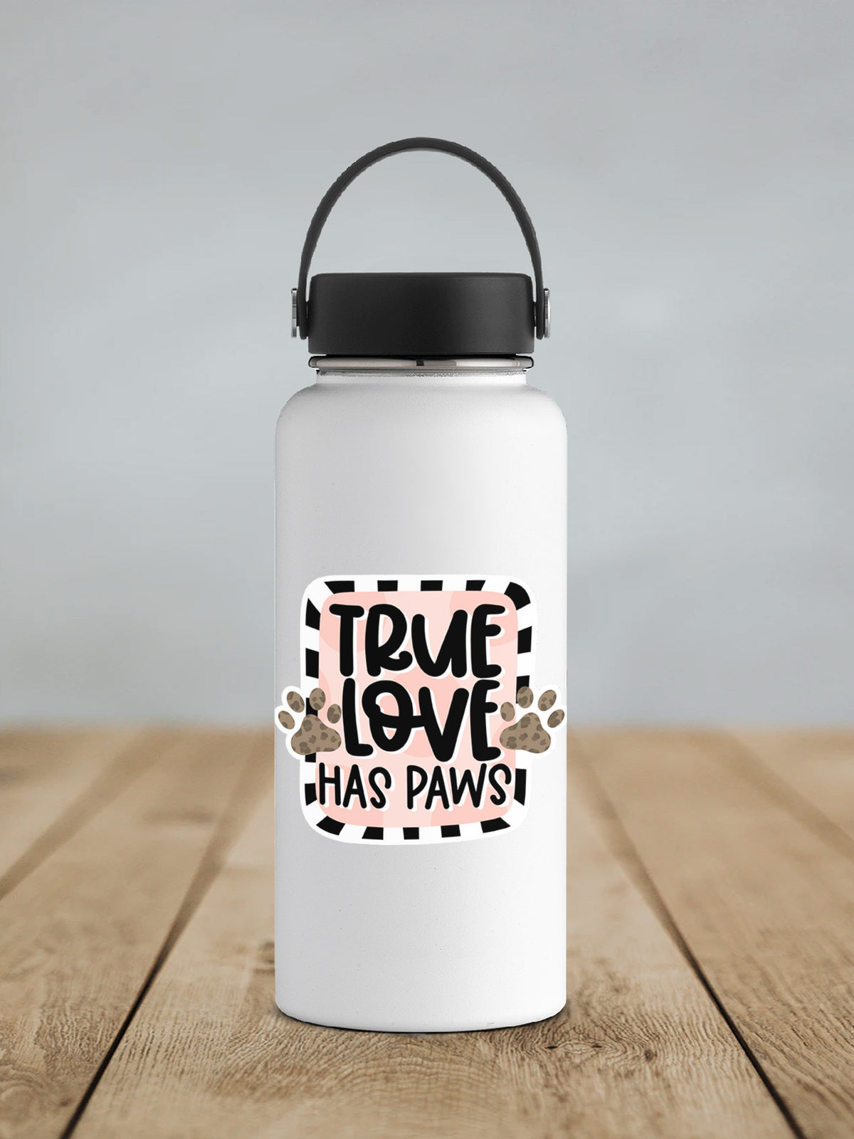 a white water bottle sitting on top of a wooden table