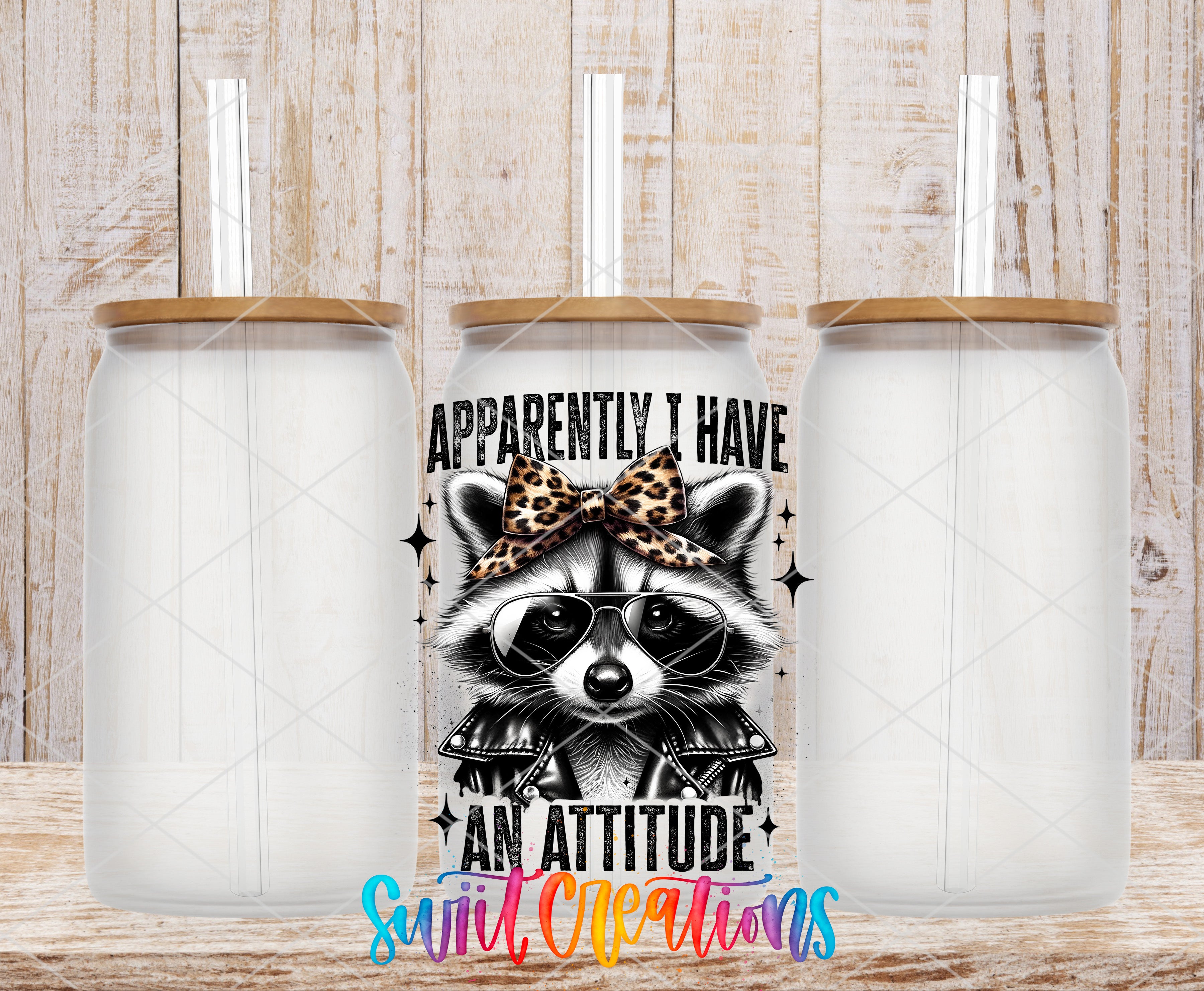 a clear glass tumbler with a leopard print bow on it, and there is a text design on the tumbler that says "Approximately I Have An Attitude".