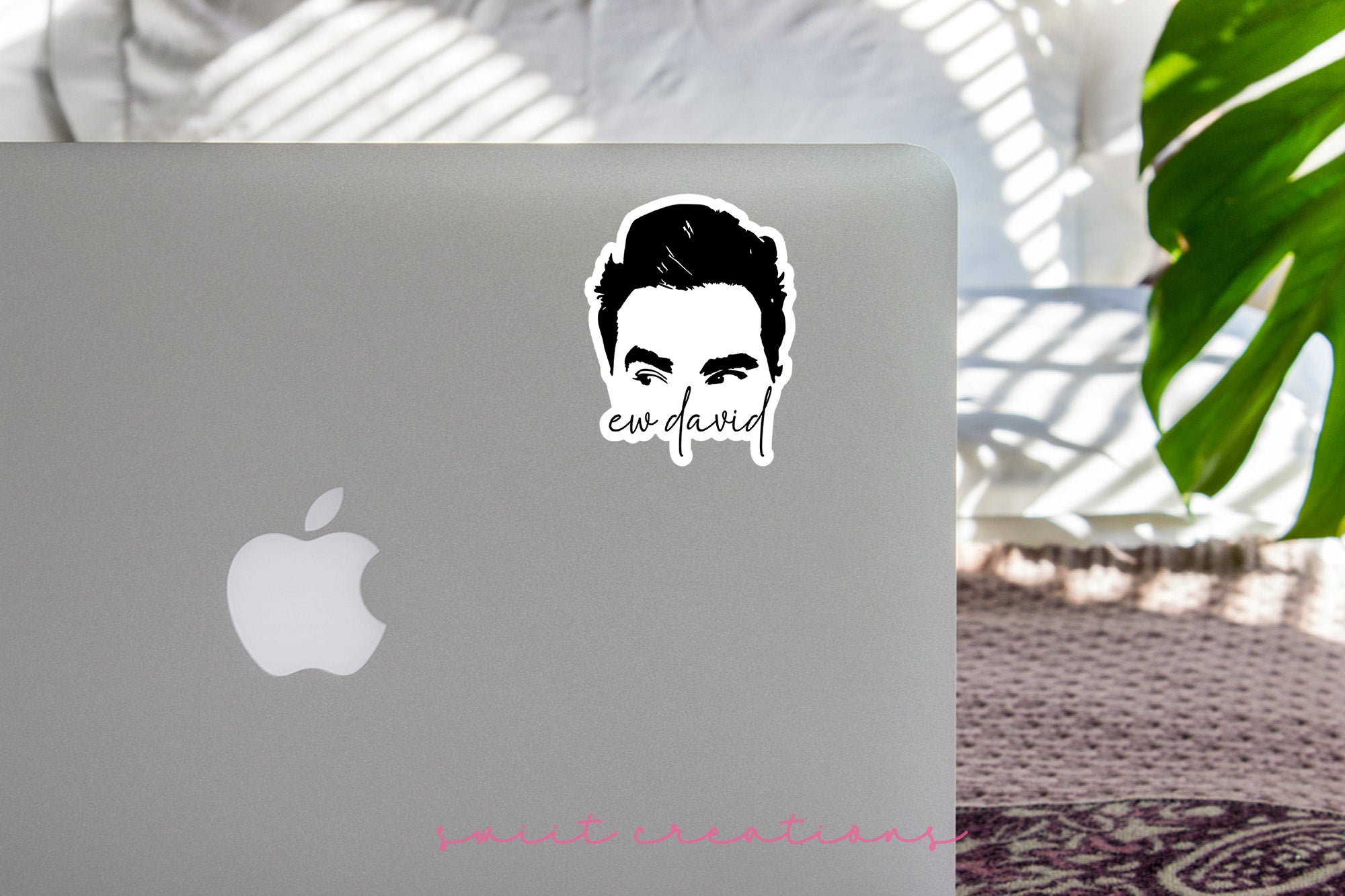 a laptop with a sticker of a man's face
