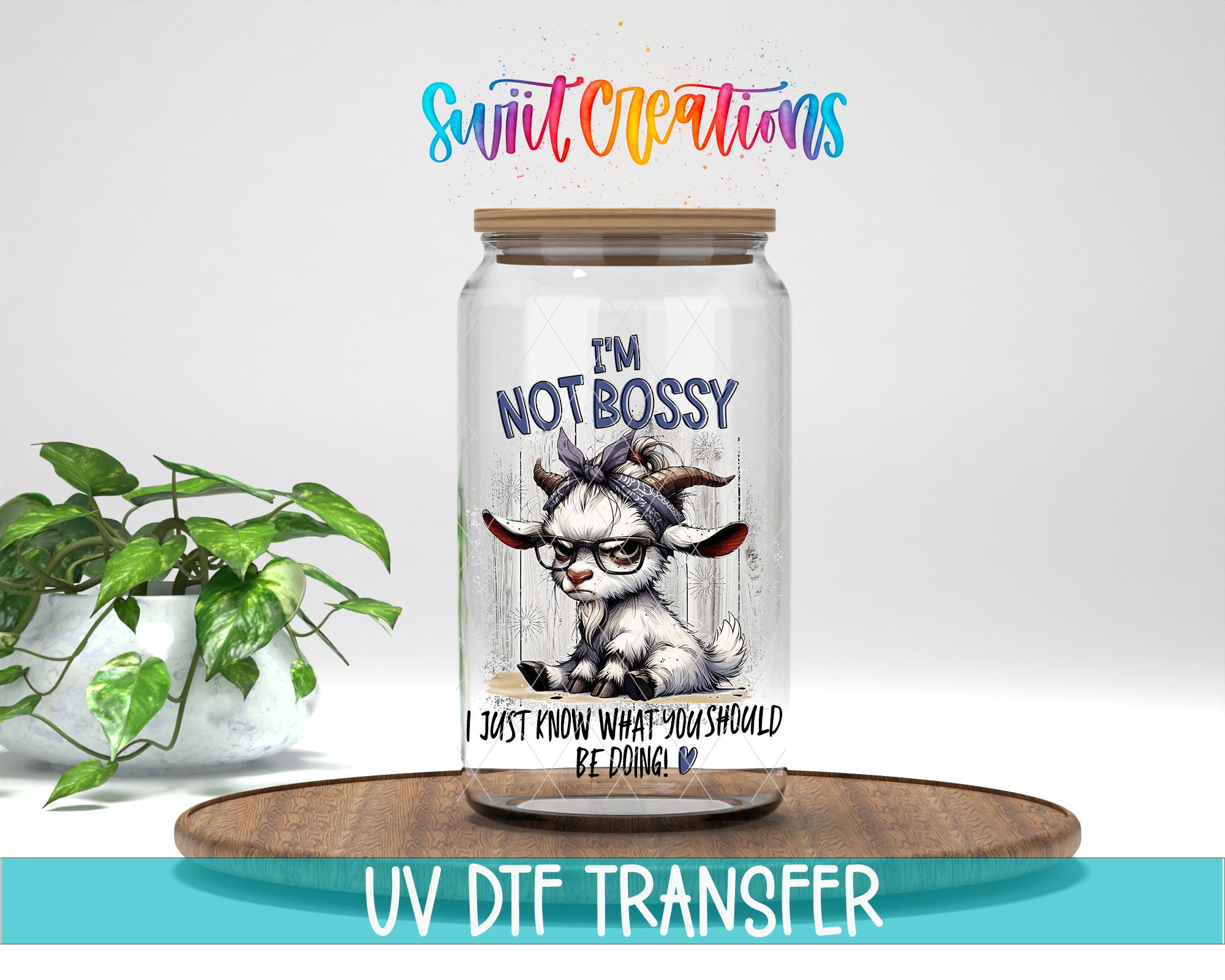 a glass jar with a label that says "I'm not bossy" and includes a cartoon goat wearing glasses. The jar is placed on a wooden surface, and there is a potted plant in the background.