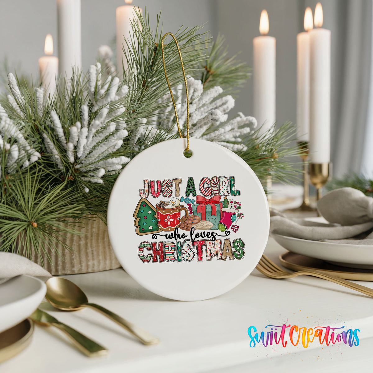A white ceramic ornament with a festive Christmas design, featuring a snowman, presents, and the text "Just a girl who loves Christmas". The ornament is placed on a table with a candle and other holiday decorations.
