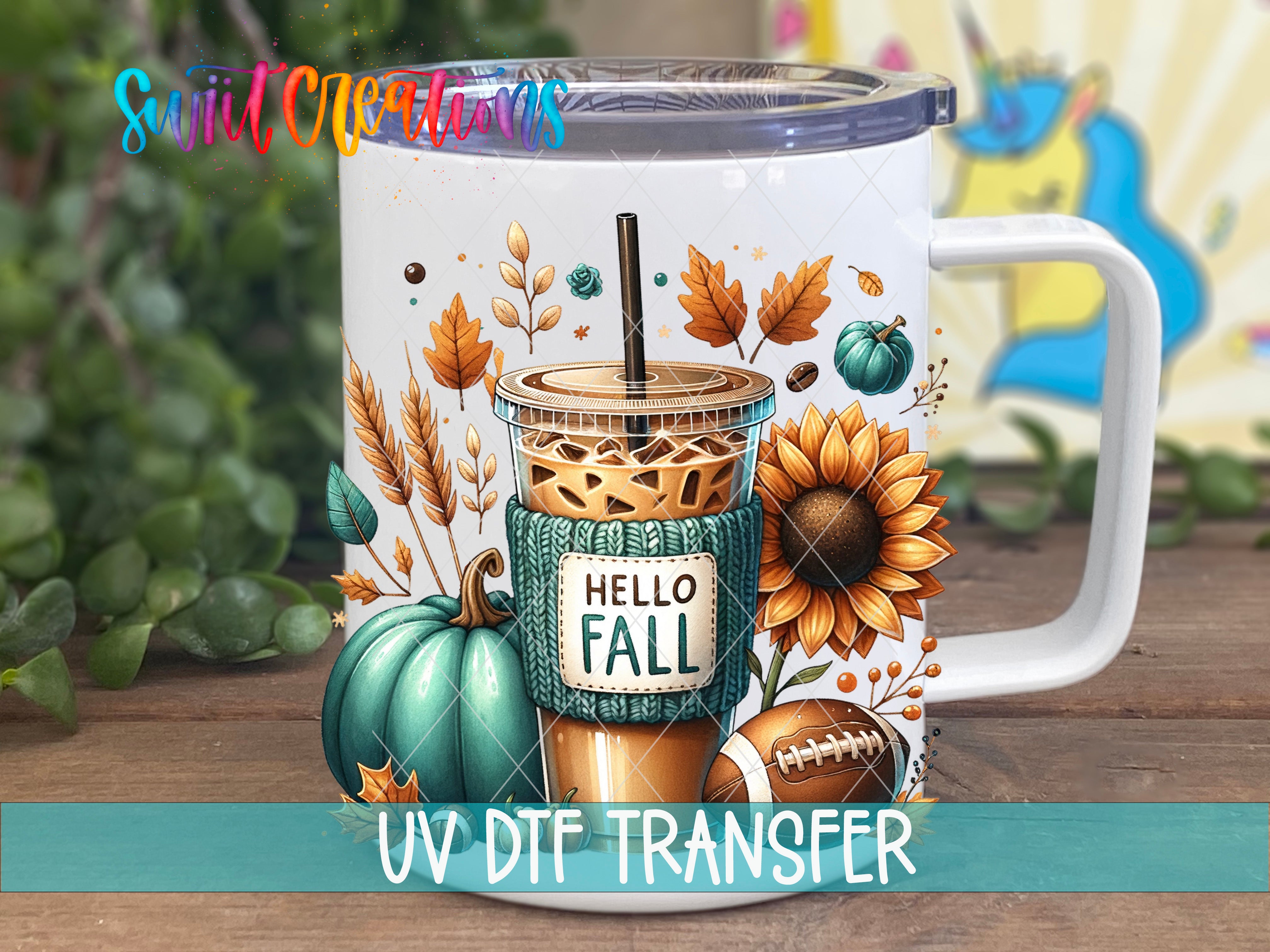 A white mug with a colorful autumn-themed design, including a coffee drink, pumpkins, sunflowers, and leaves.