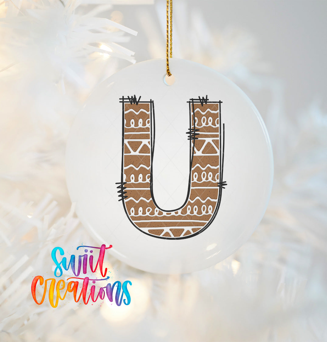 A white ornament with a brown and white patterned design, resembling a letter "U".
