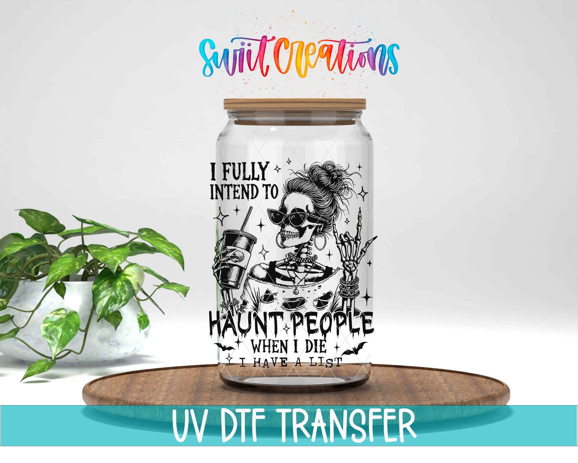 A glass jar with a skeleton design and text, placed on a wooden surface next to a potted plant.