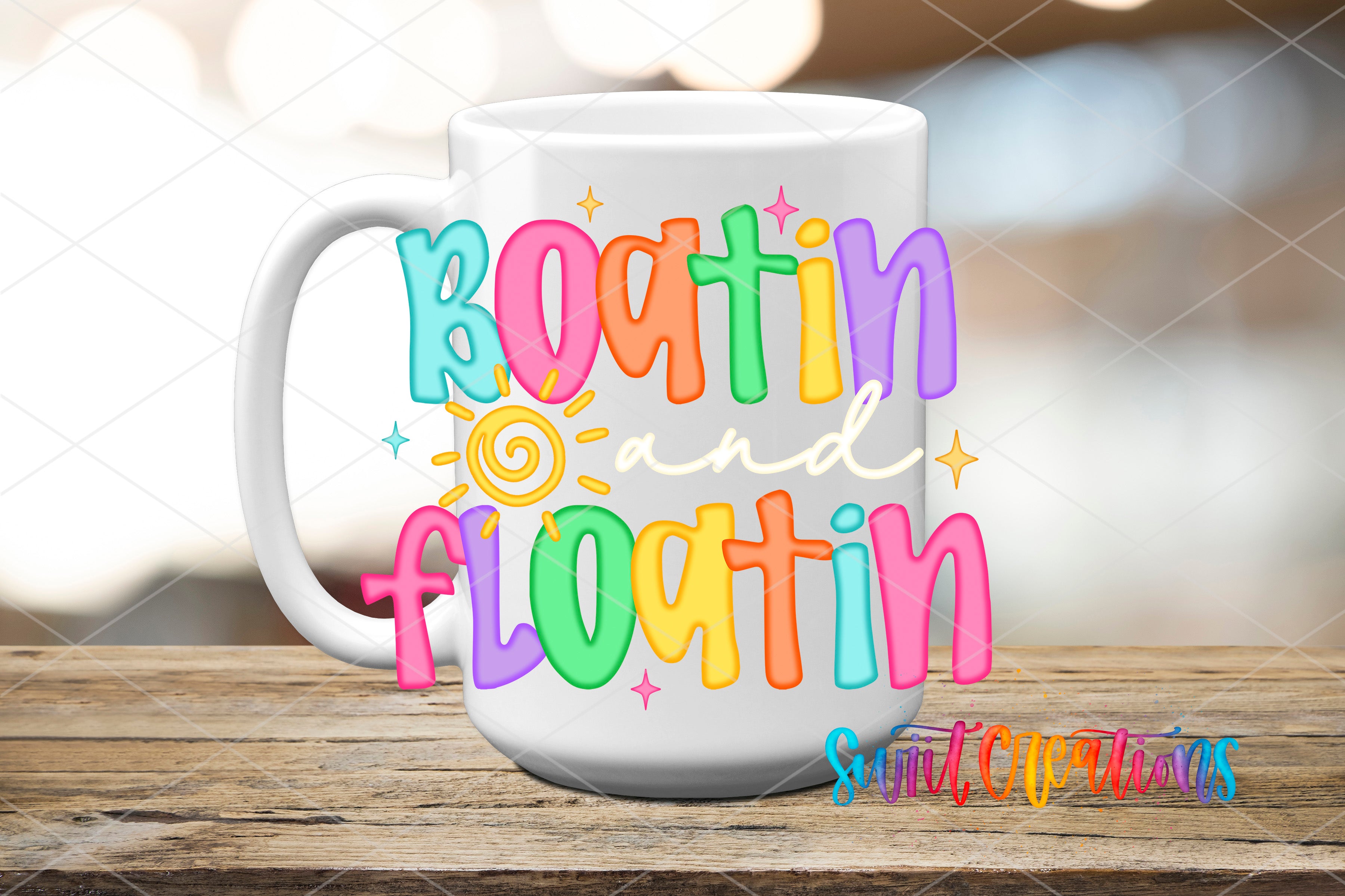 A white mug with colorful text that says "Boatin and floatin" on it, placed on a wooden surface.