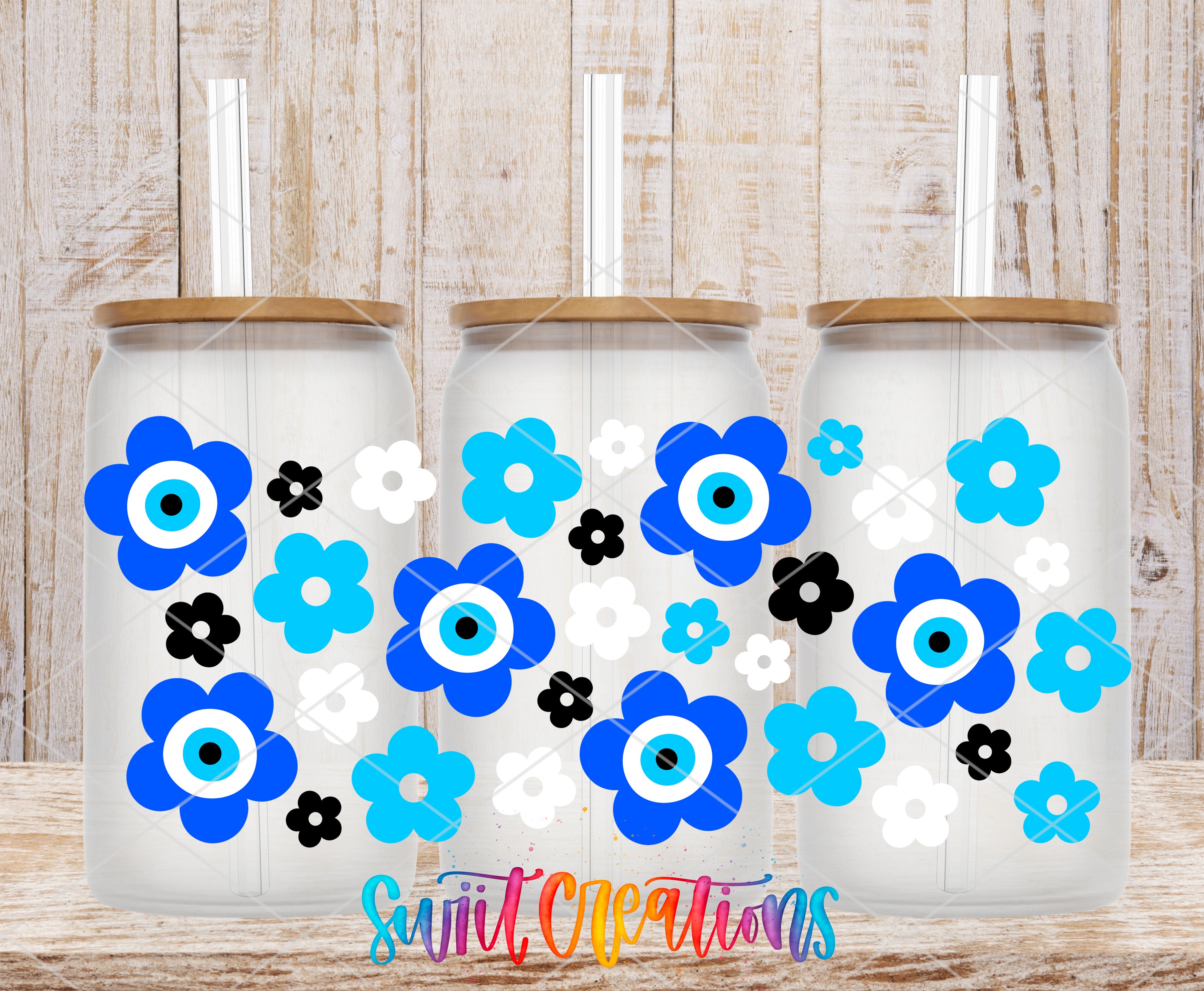 three glass jars with blue and white flower designs on them, placed on a wooden surface.