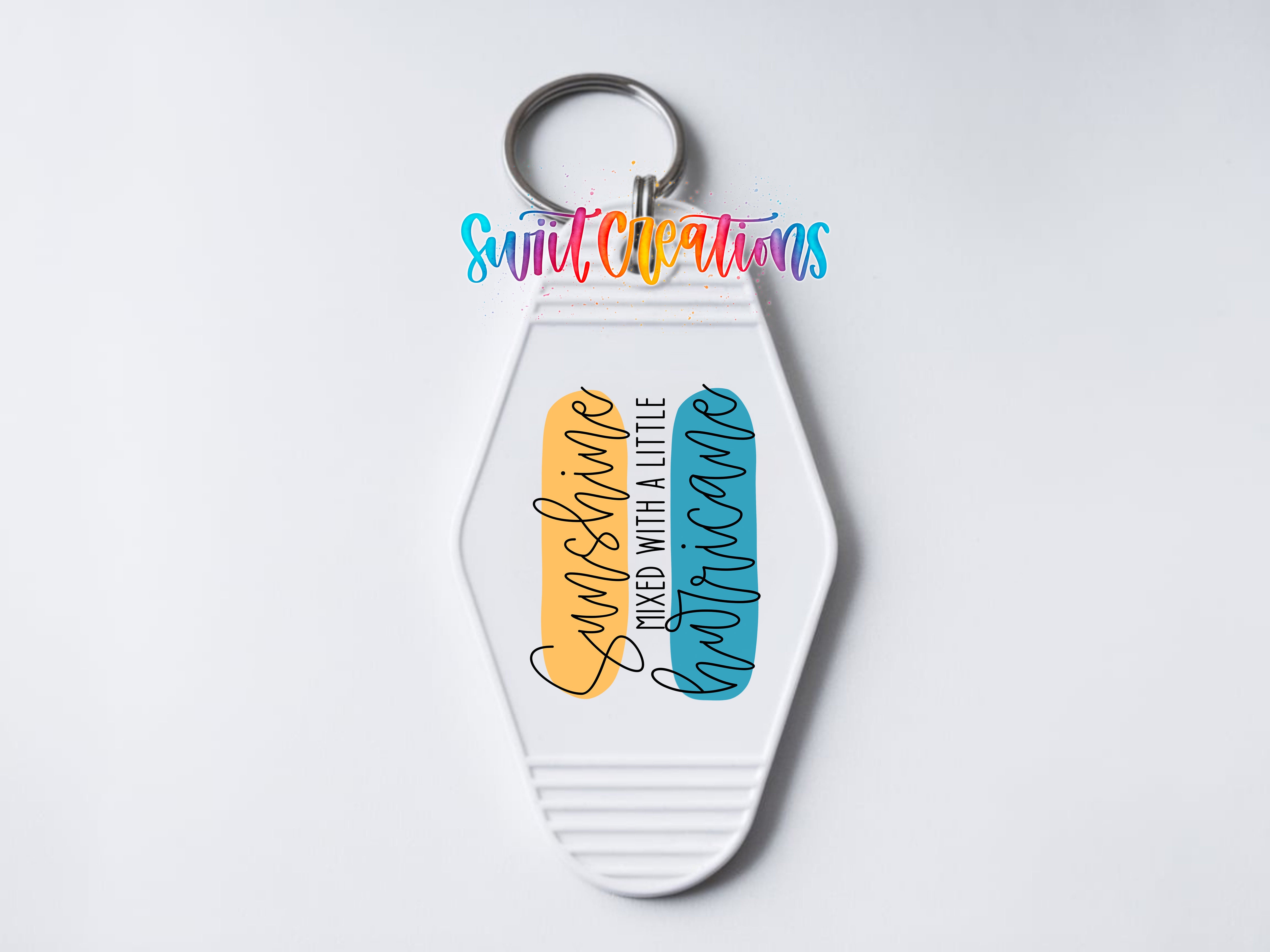 A keychain with a colorful design featuring the text "Sunshinning mixed with a little Hurricane" and a graphic of a sun and a storm cloud.