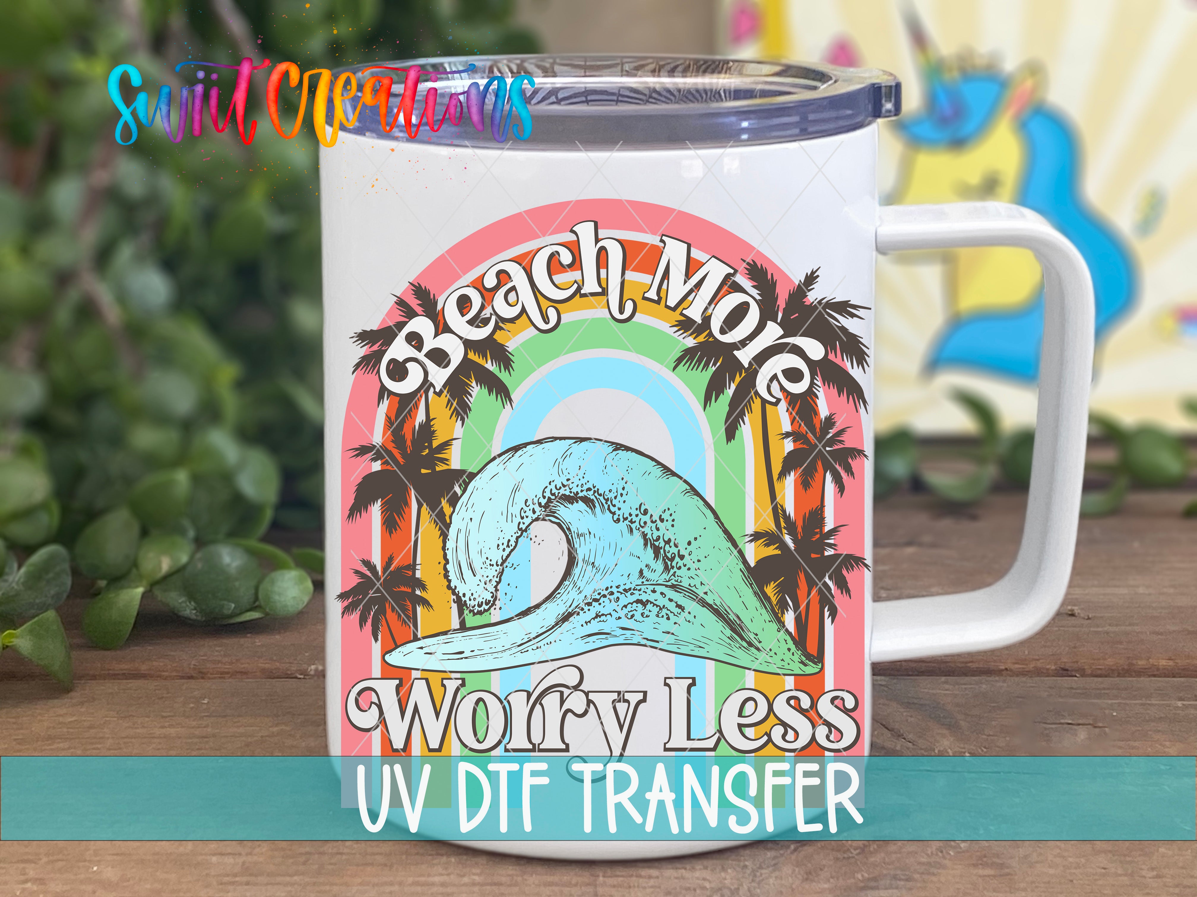 A white mug with a colorful graphic design featuring a wave, palm trees, and a rainbow. The text on the mug reads "Beach Mole Worry Less UV Dtf Transfer".