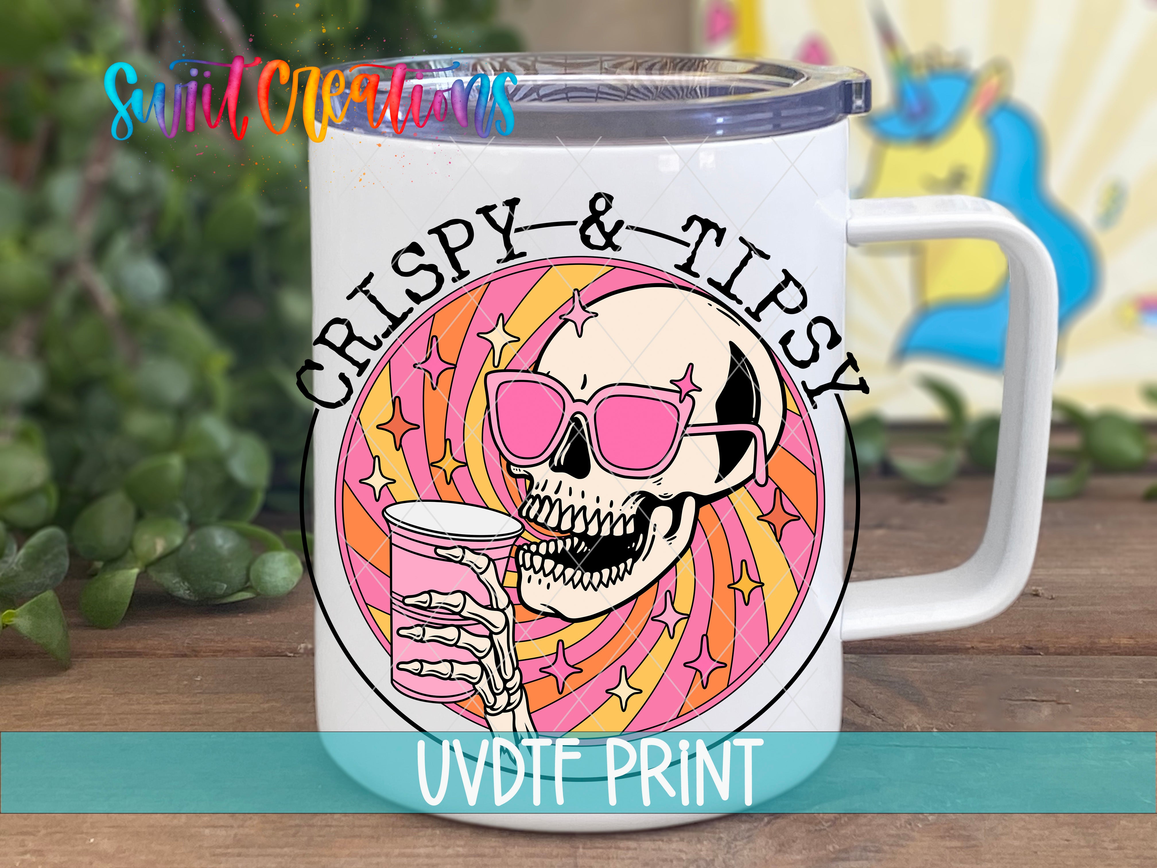 A white mug with a colorful design featuring a skull wearing sunglasses and holding a drink, surrounded by a swirling pattern of pink, orange, and yellow colors.
