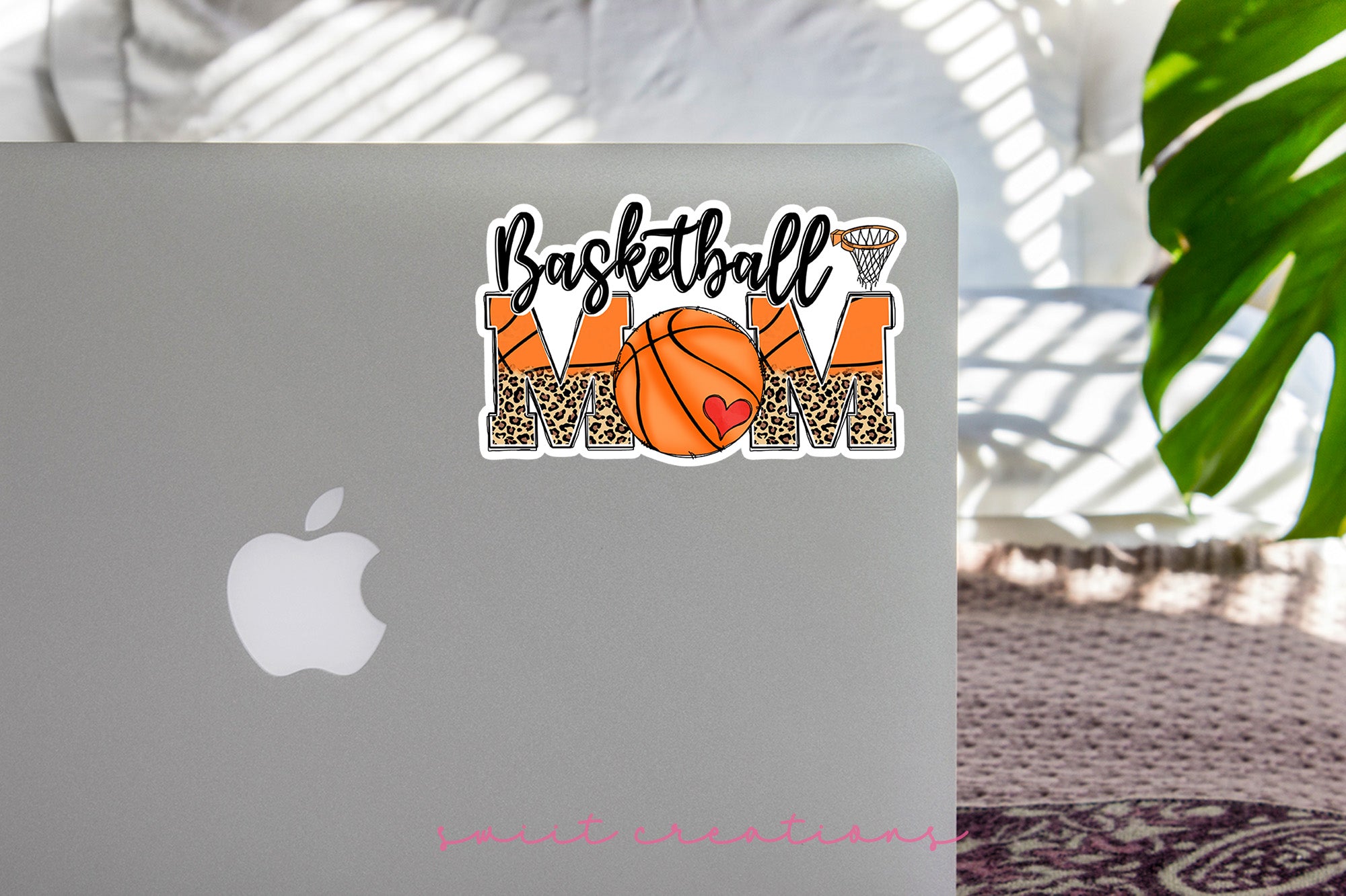 a laptop with a basketball mom sticker on it