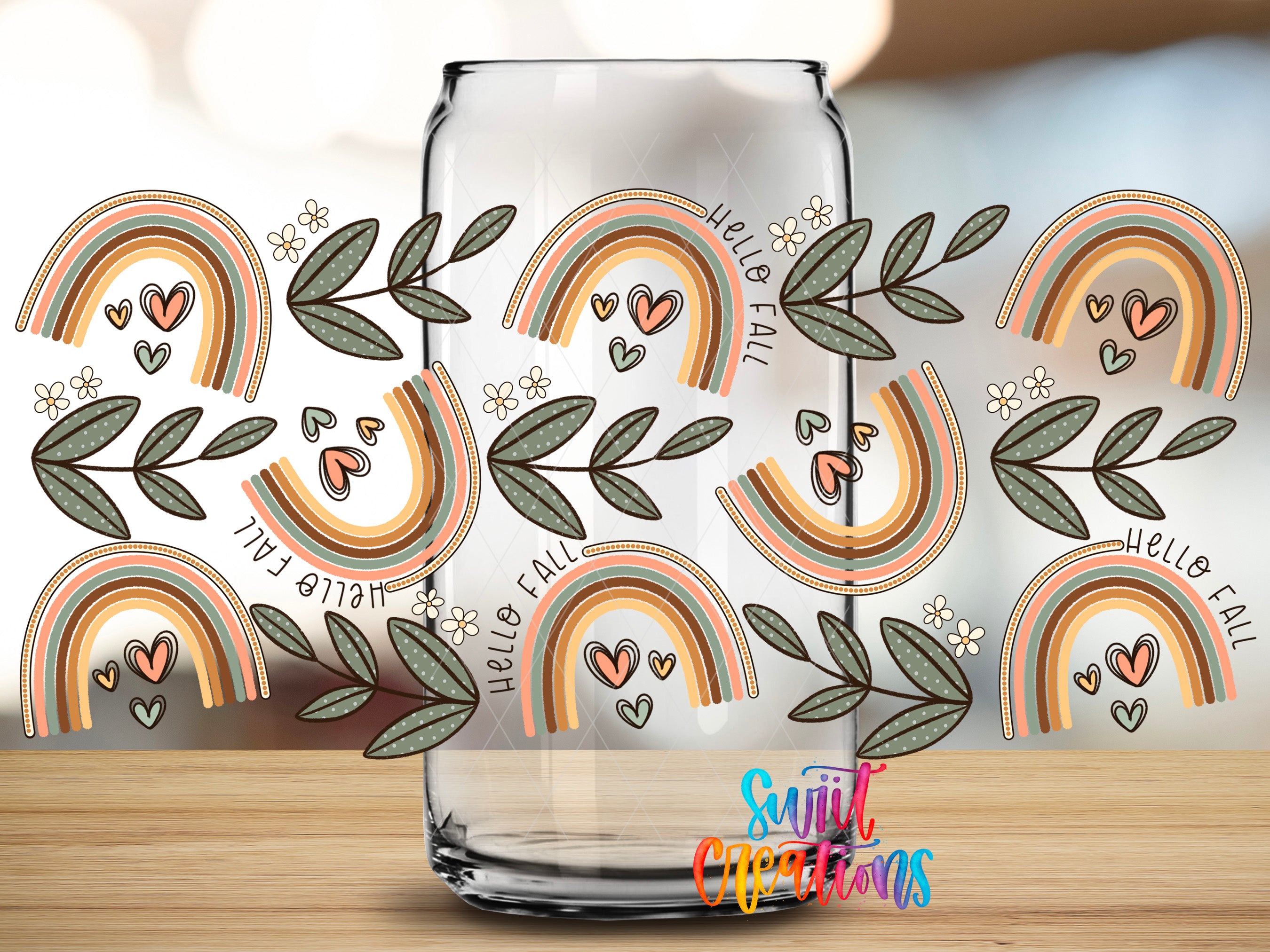 a glass jar with a repeating pattern of colorful rainbows and leaves on a wooden surface.