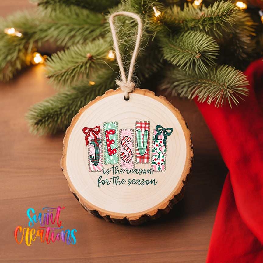 A wooden ornament with the word "JESUS" spelled out in colorful letters, hanging on a Christmas tree.