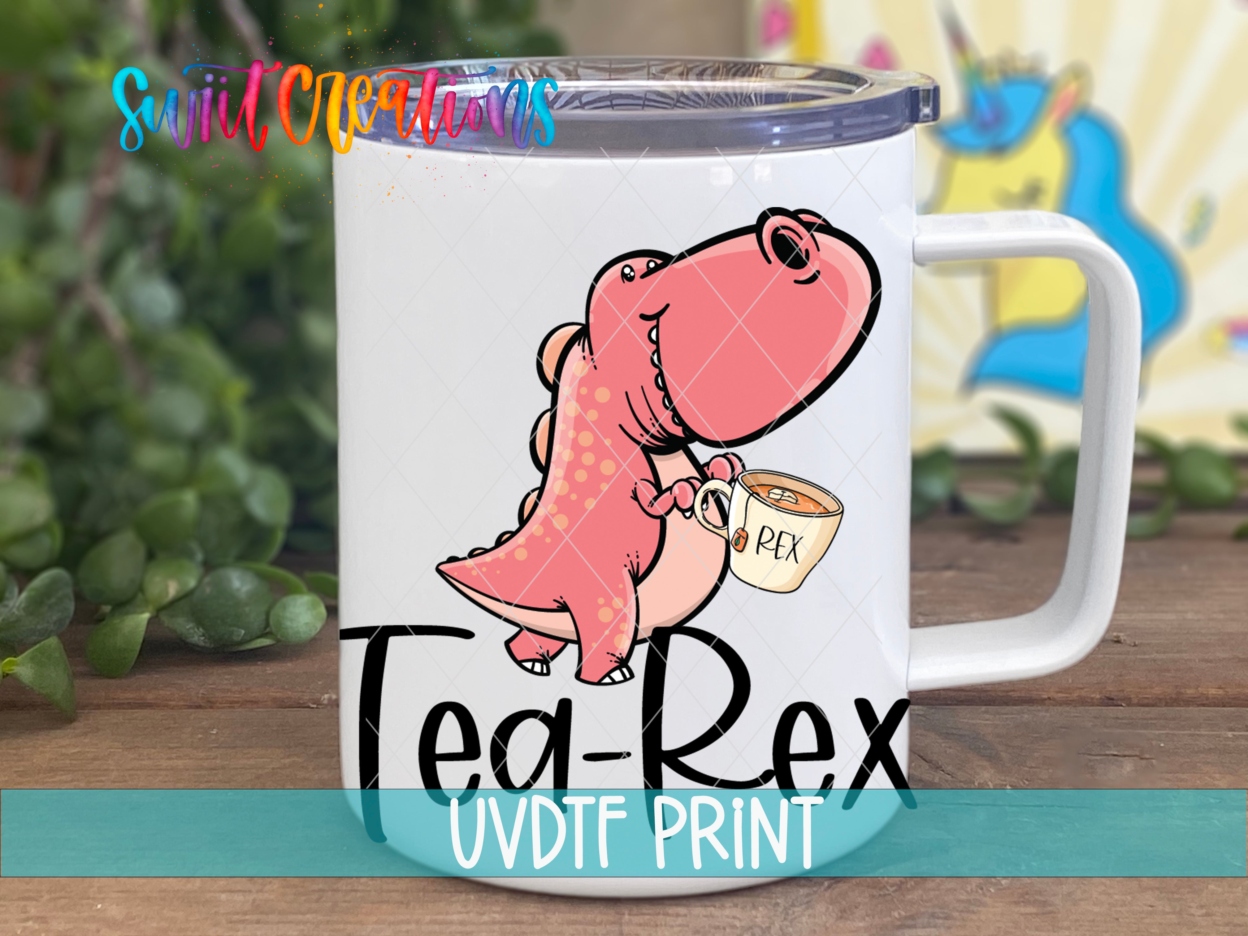 A white mug with a cartoon dinosaur holding a cup of tea, accompanied by the text "Tea-Rex" and "UVDF PRINT".