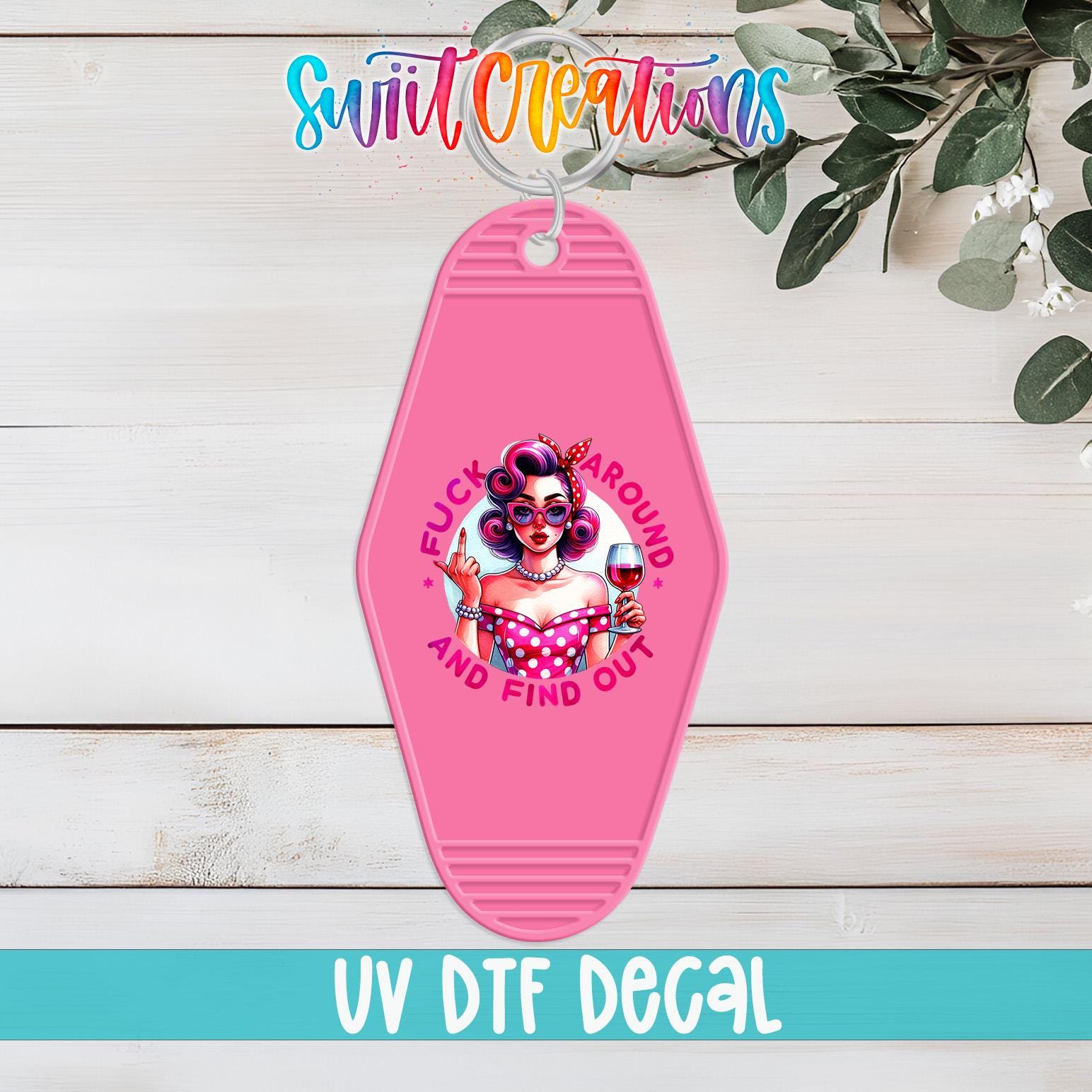 A pink keychain with a graphic design featuring a woman with curly hair and a pink dress, along with the text "FUCK AROUND AND FIND OUT" and "UV DTF DECAL".