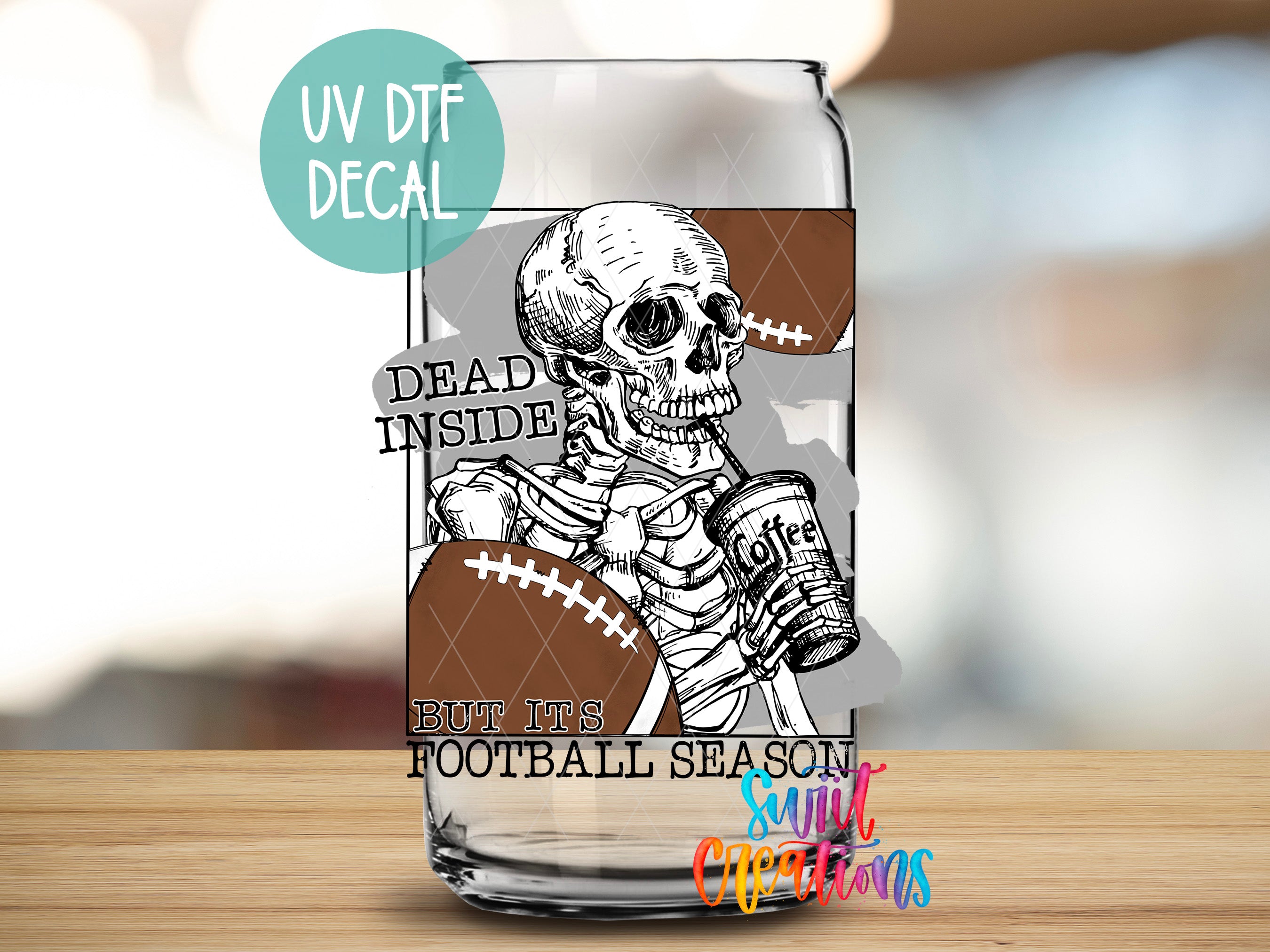 a glass with a skull holding a football
