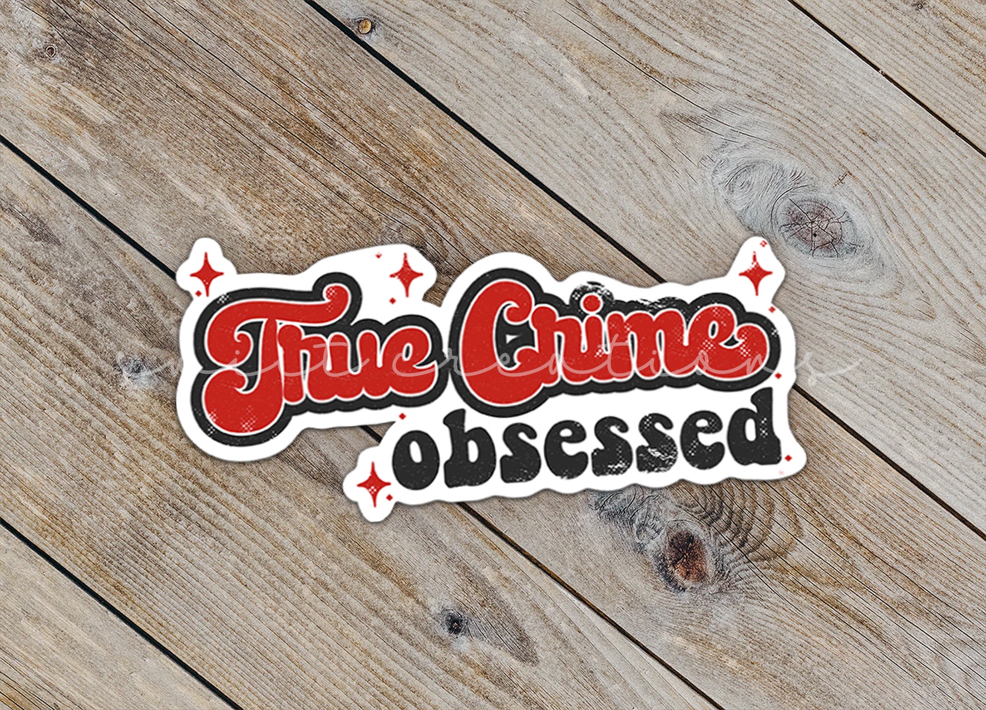 a sticker that says, the crime observed on a wooden surface