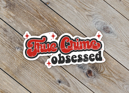 a sticker that says, the crime observed on a wooden surface