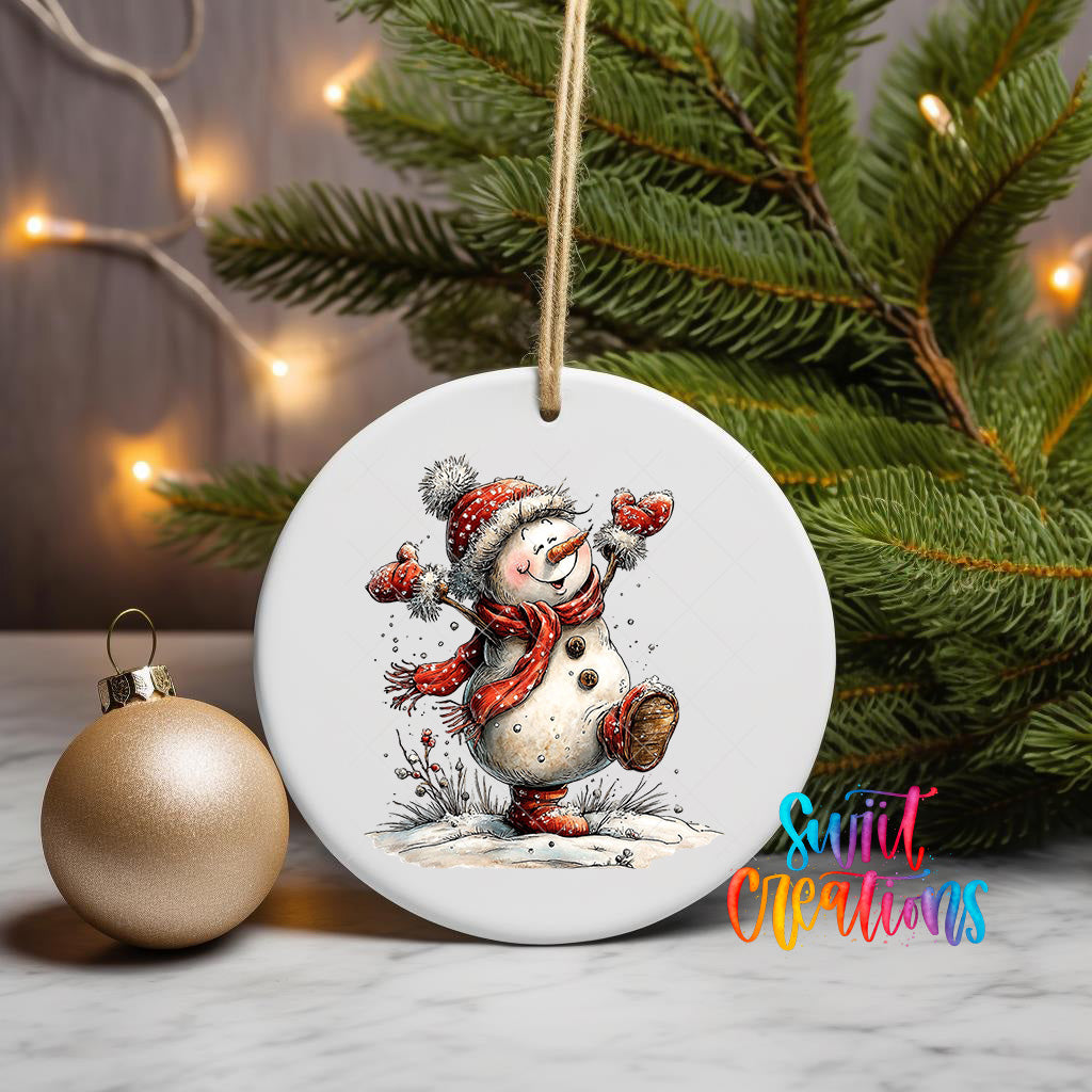 A white ceramic ornament featuring a snowman is displayed on a table, with a Christmas tree and twinkling lights in the background.