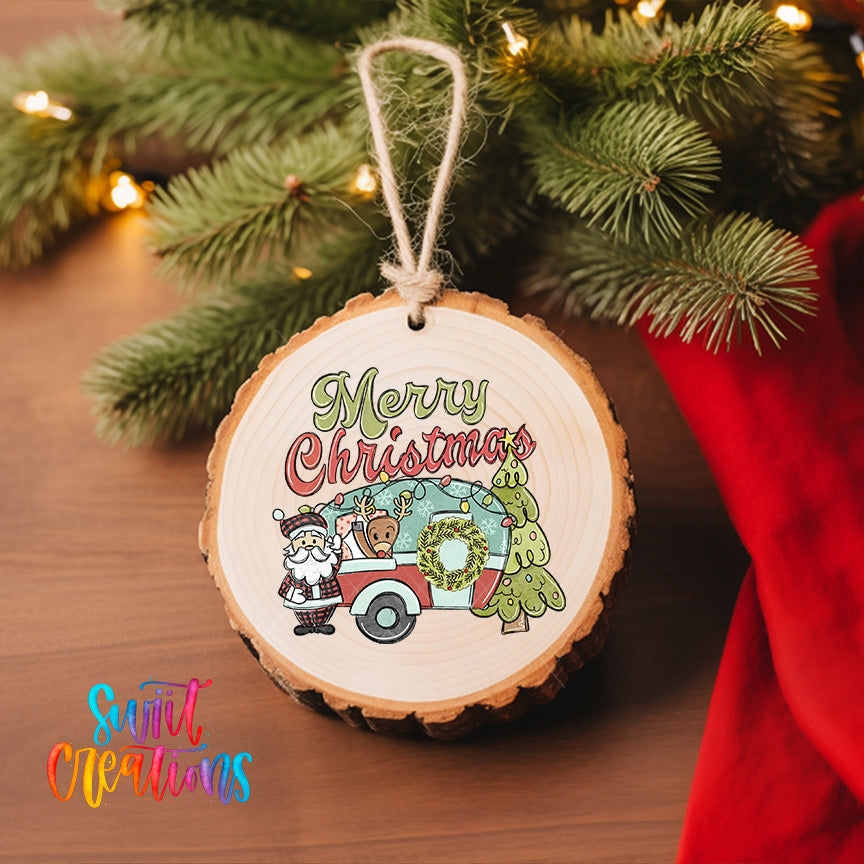A wooden ornament with a Santa Claus and reindeer design, along with the text "Merry Christmas" hanging from a string. The ornament is placed on a Christmas tree, and there is a red cloth visible in the background.