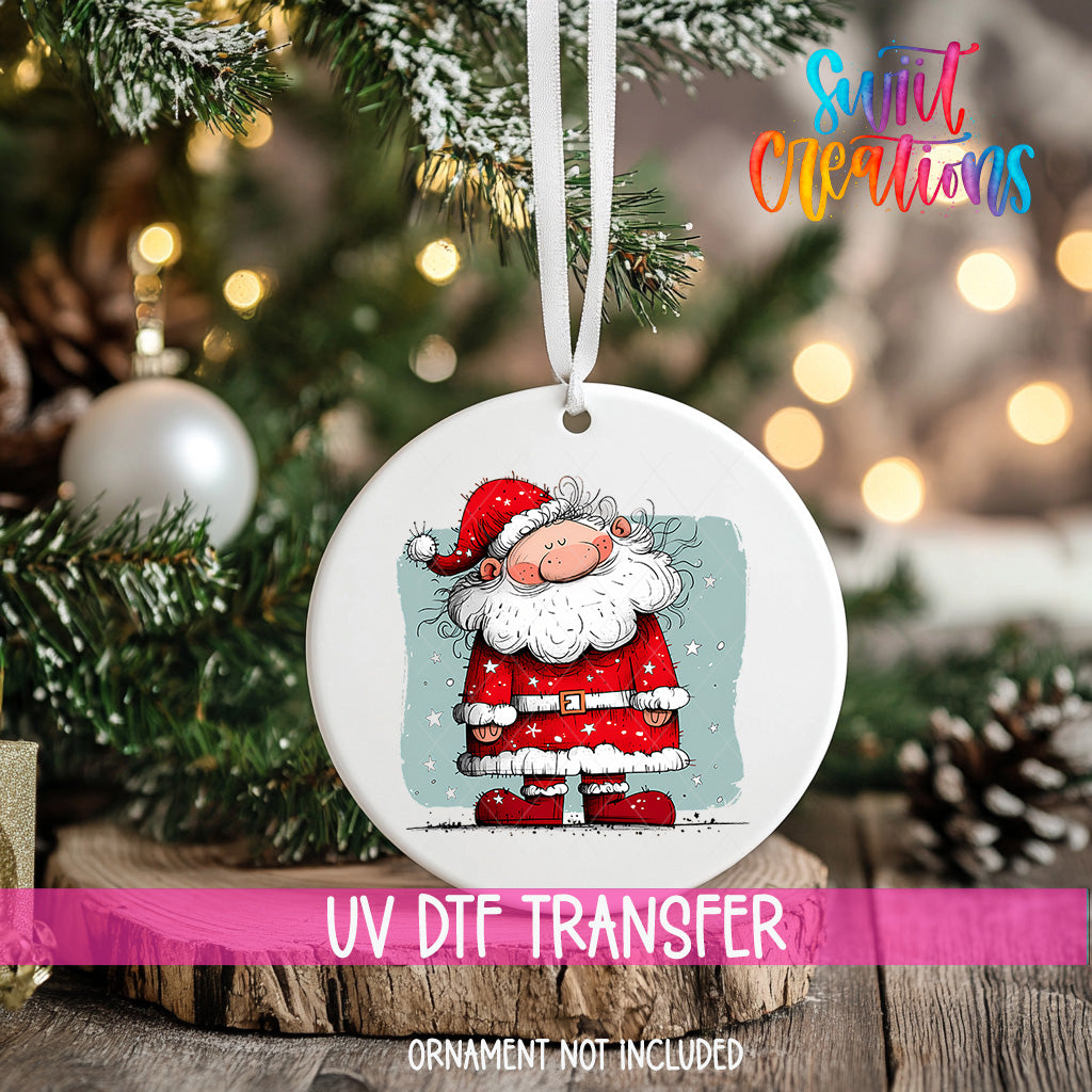 A white ceramic ornament featuring a cartoon Santa Claus figure is hanging on a Christmas tree.