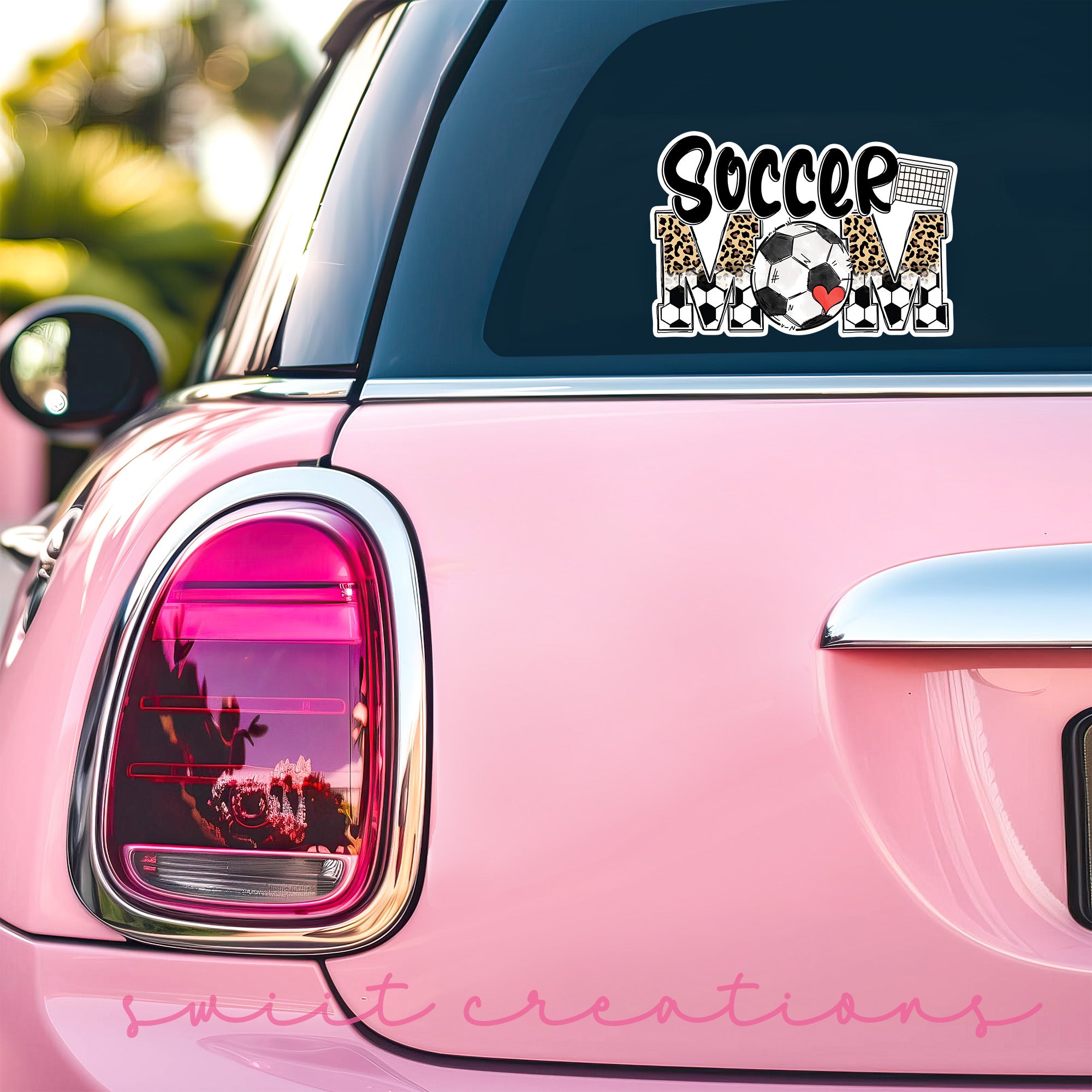 a pink car with a soccer sticker on it