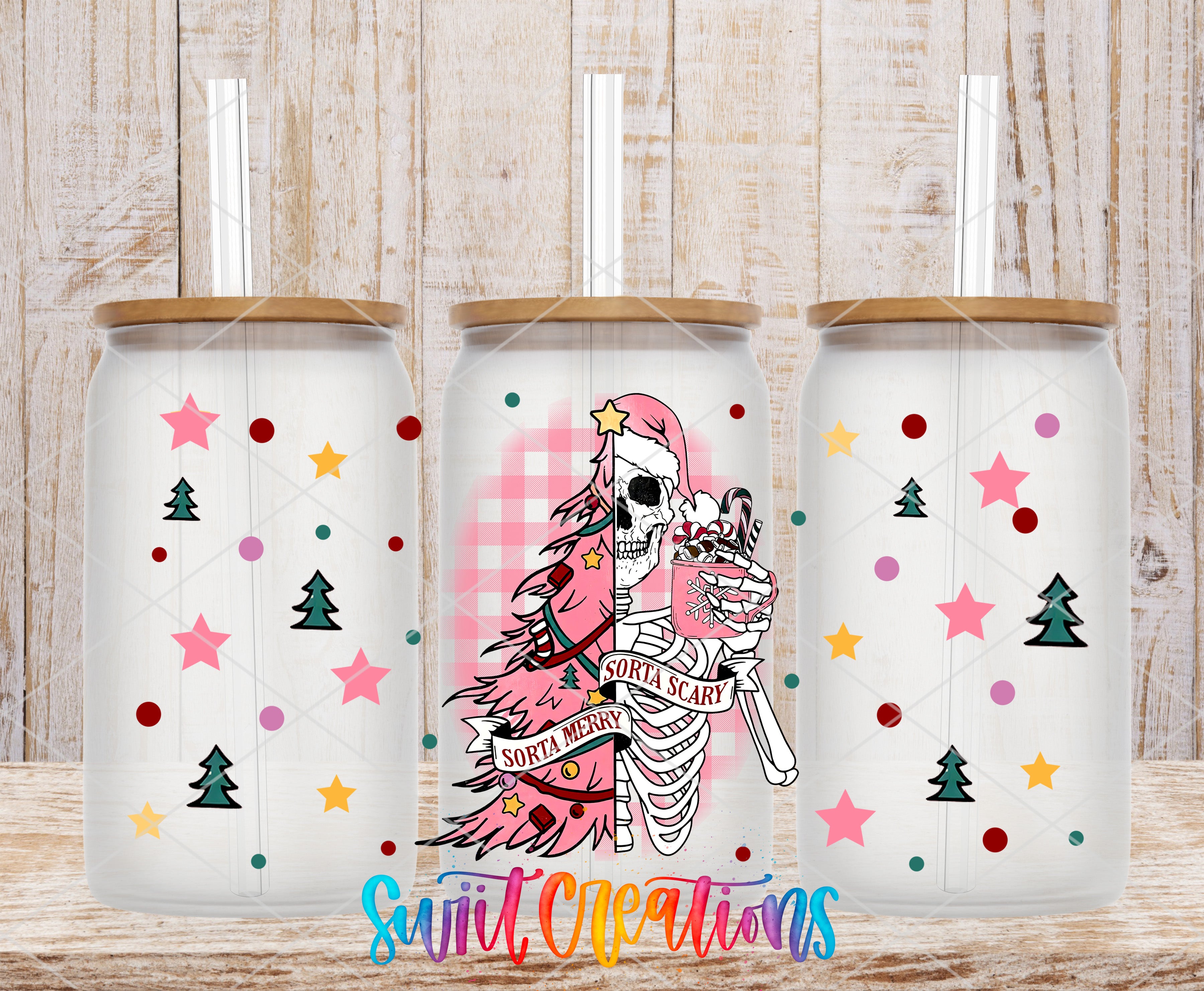 three glass tumblers with a unique design. The tumblers have a skeleton wearing a Santa hat and holding a cup of hot chocolate, surrounded by Christmas-themed decorations such as stars, pine trees, and snowflakes.