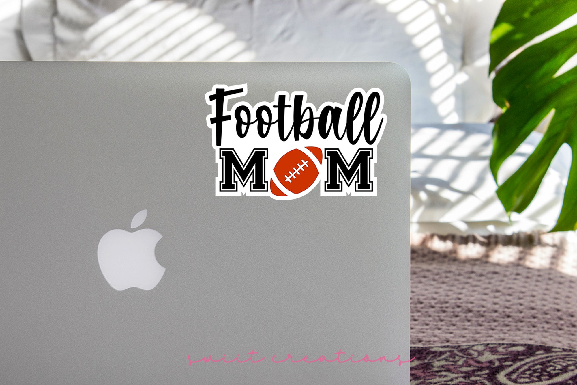 a laptop with a football mom sticker on it