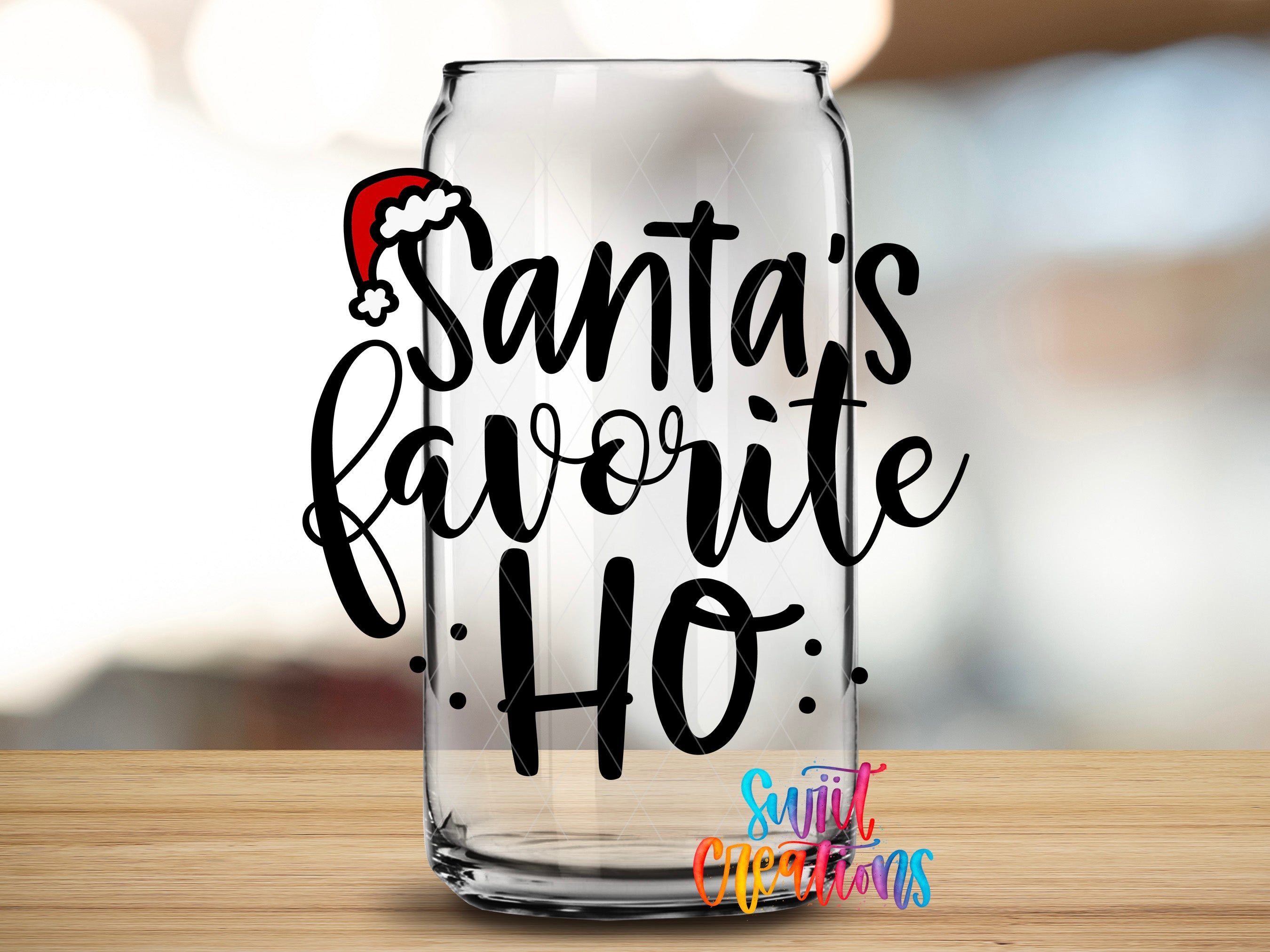 A clear glass can with the text "Santa's favorite ho" written on it, along with a small Santa Claus hat icon.