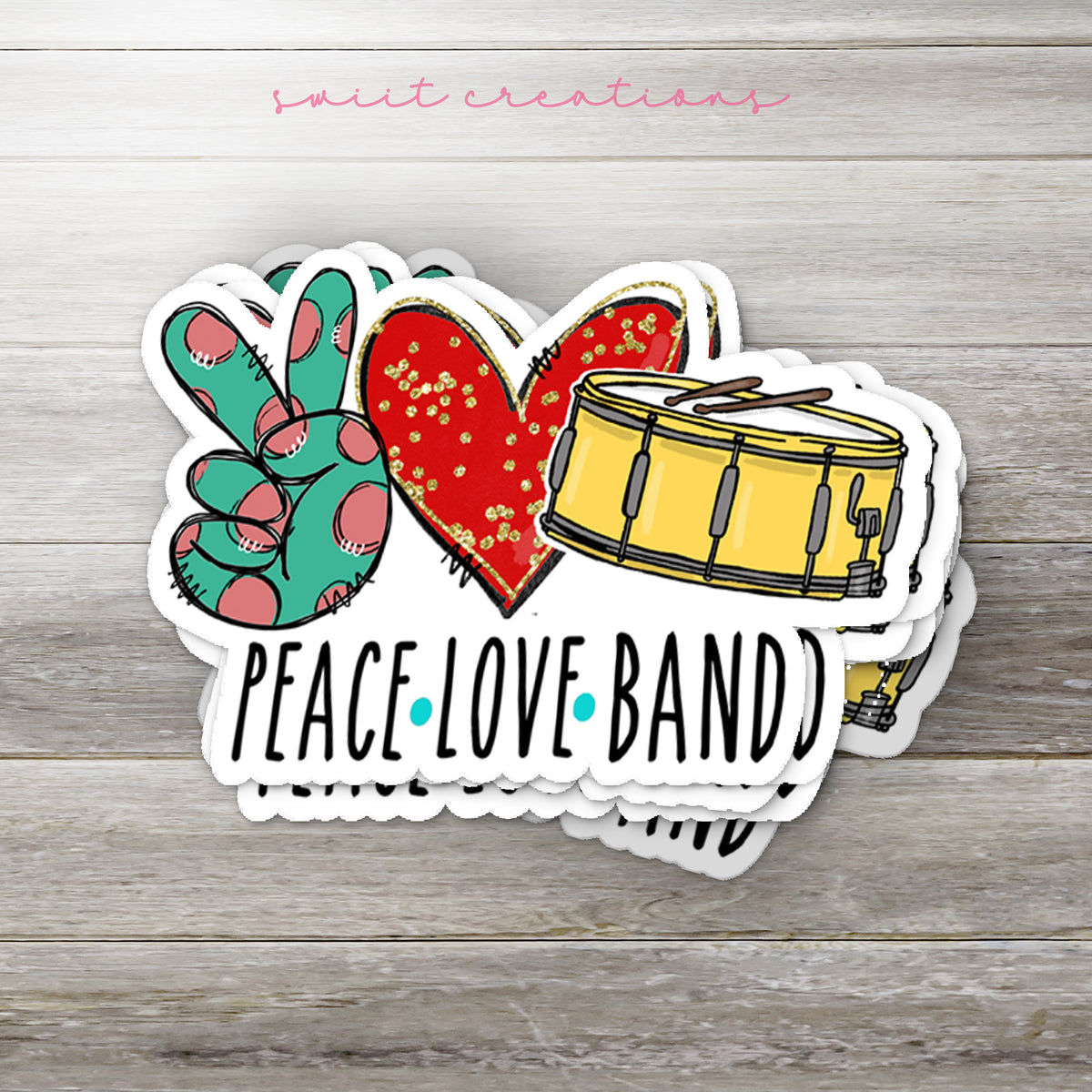 a peace love band sticker sitting on top of a wooden table
