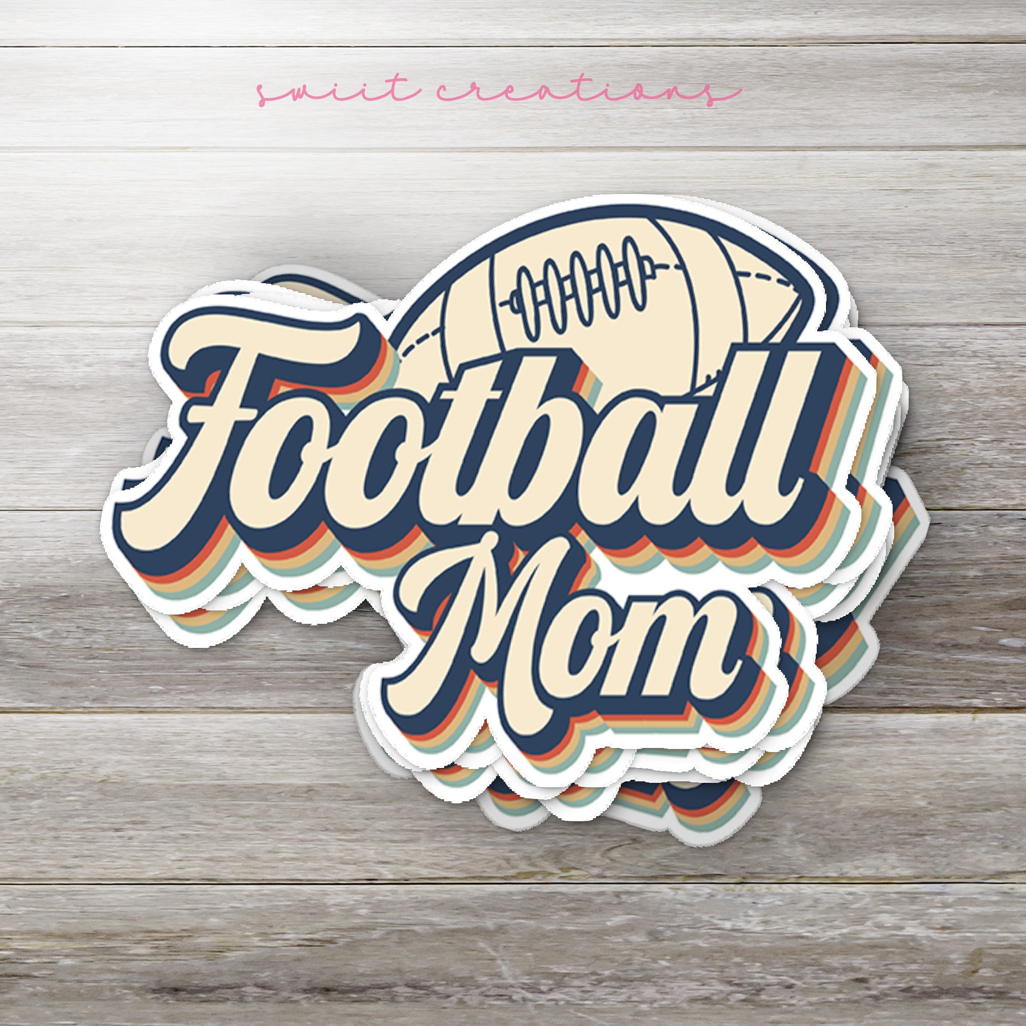 a football mom sticker sitting on top of a wooden table