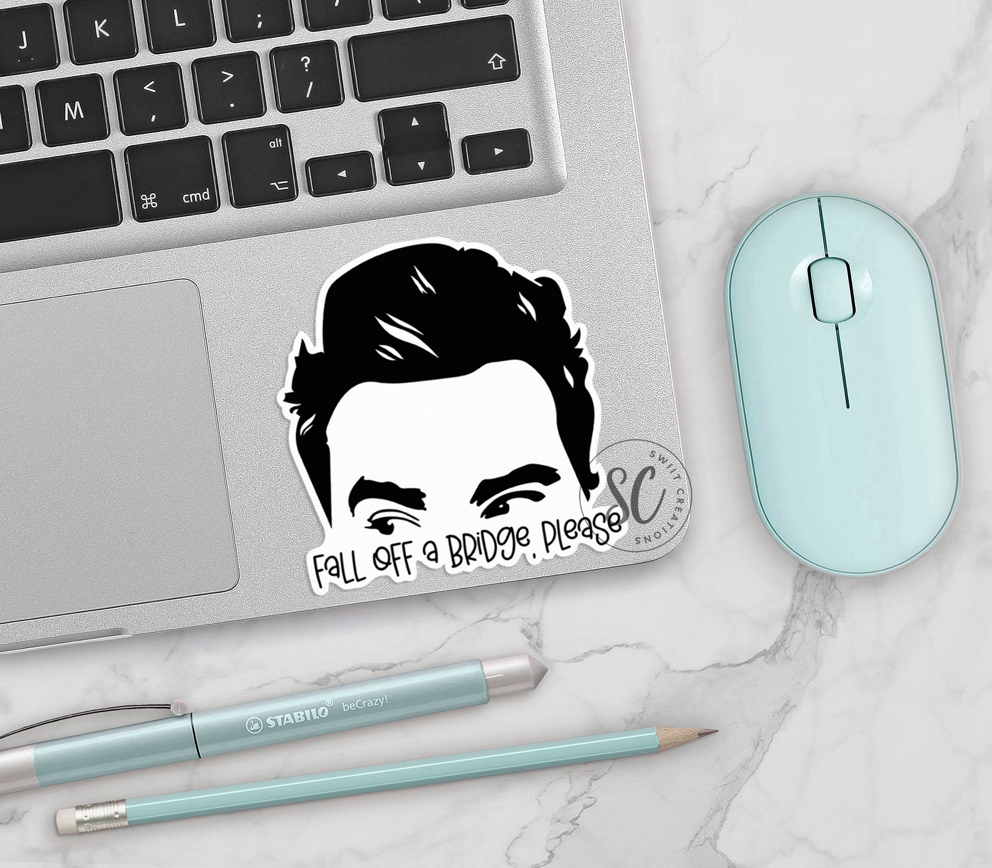 a laptop with a sticker of a man's face