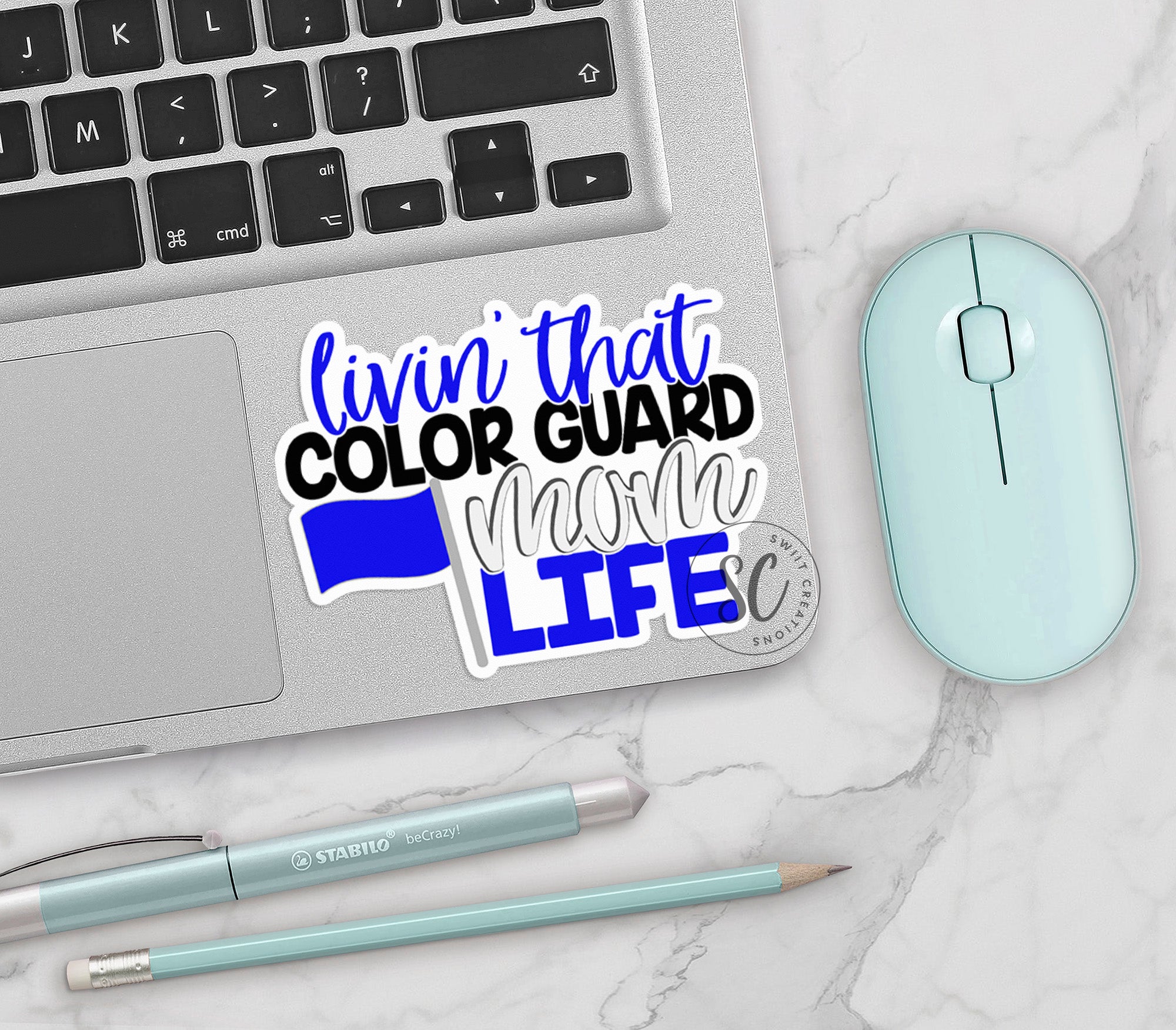 a laptop computer sitting on top of a white table