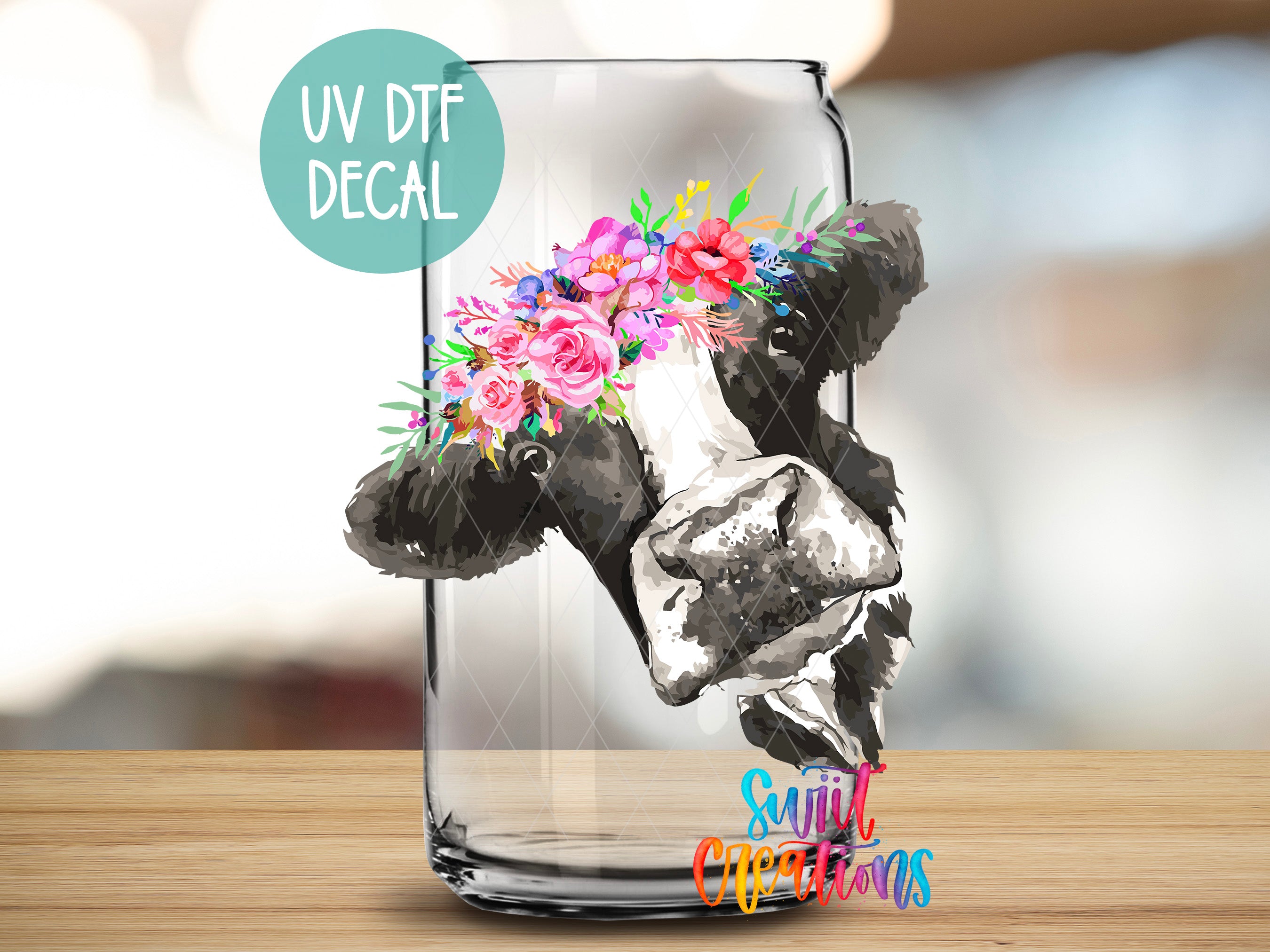 a glass vase with a cow painted on it